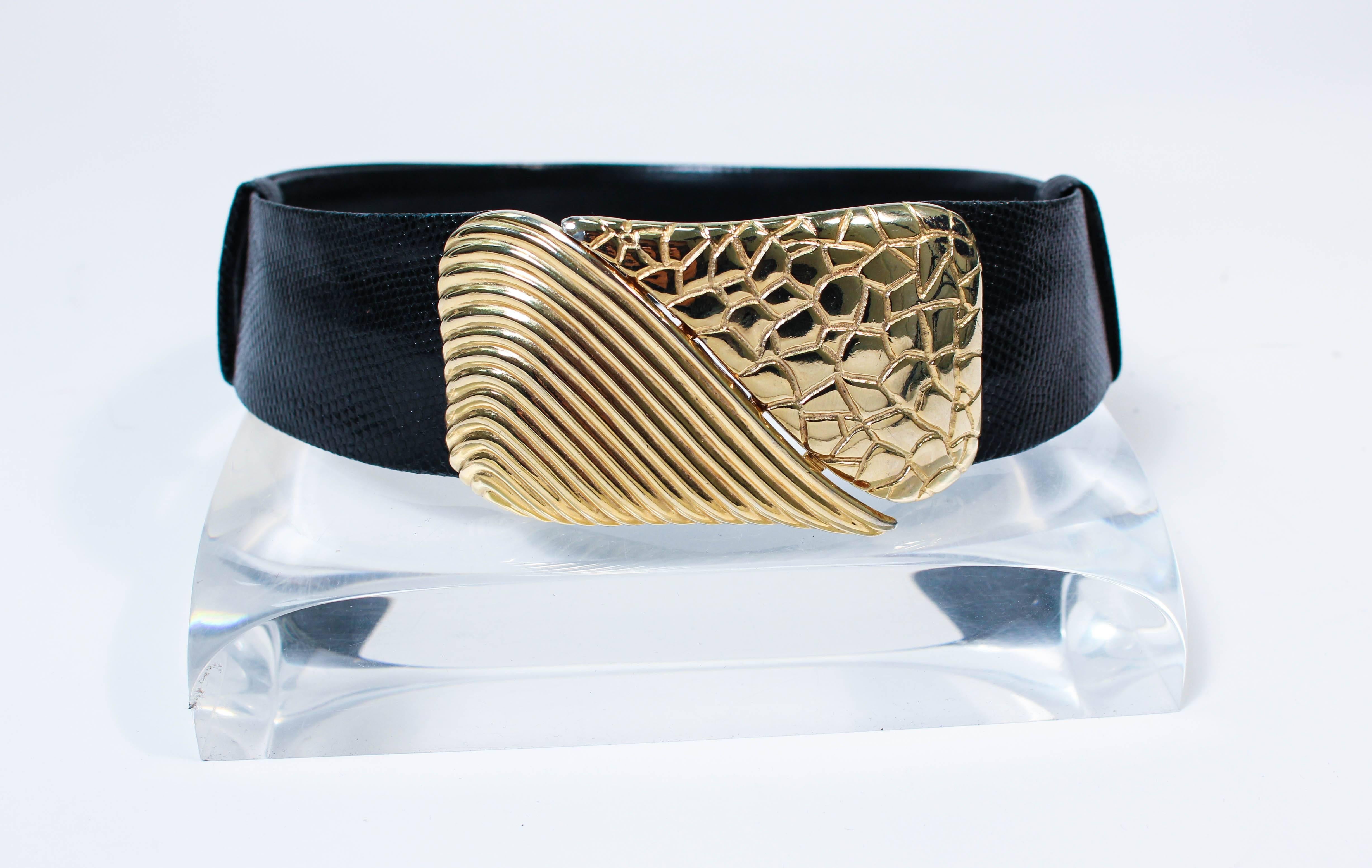 This Judith Leiber bet is composed of a black lizard. Features a stunning large gold hue belt buckle. Optional lengths with slide design. In excellent vintage condition.

**Please cross-reference measurements for personal accuracy. Size in