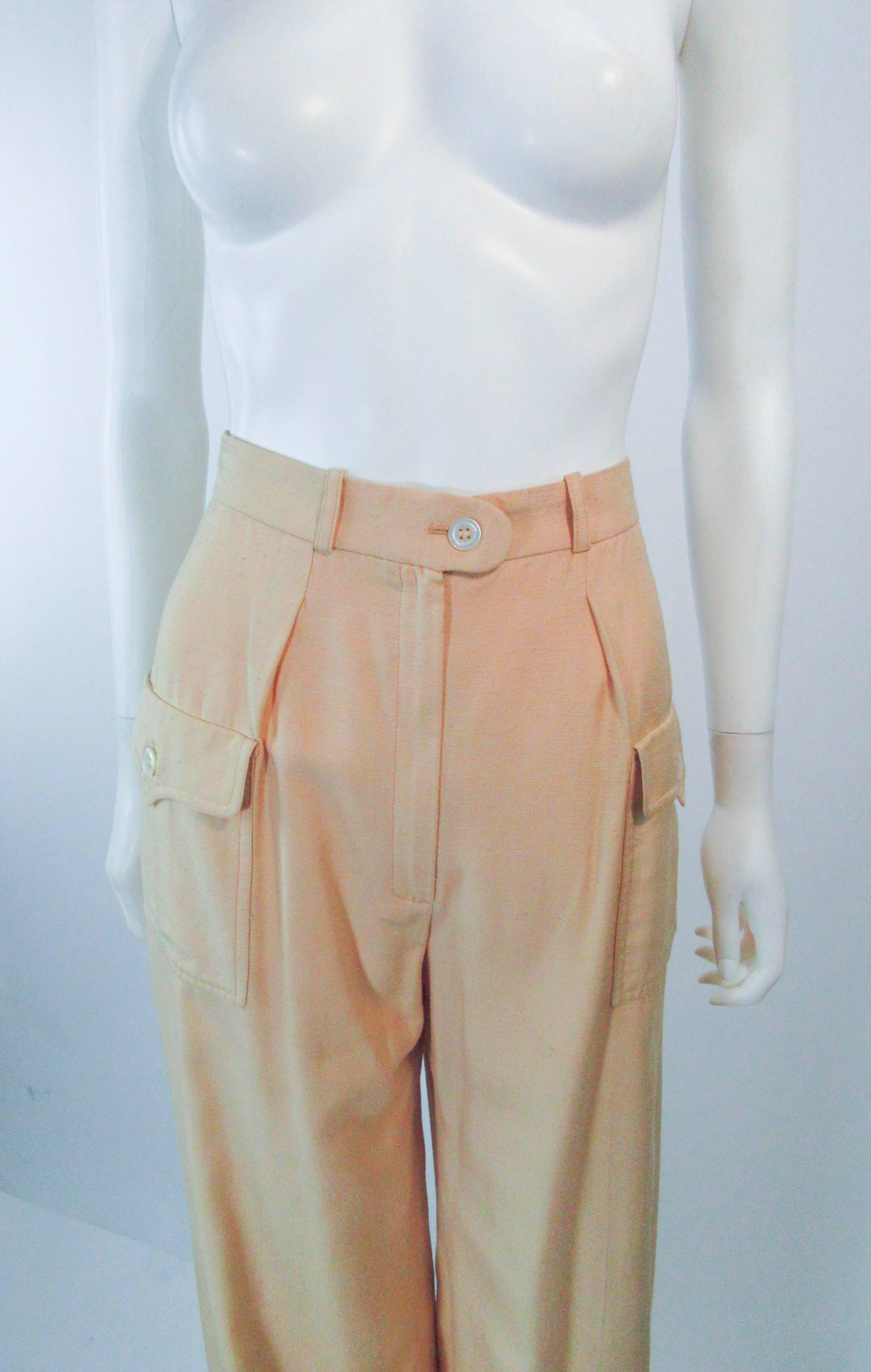 These Valentino pants are composed of a raw silk in a natural khaki color. Features a safari style with side pockets. There is a zipper closure. In good vintage condition, they are un-hemmed. 

  **Please cross-reference measurements for personal