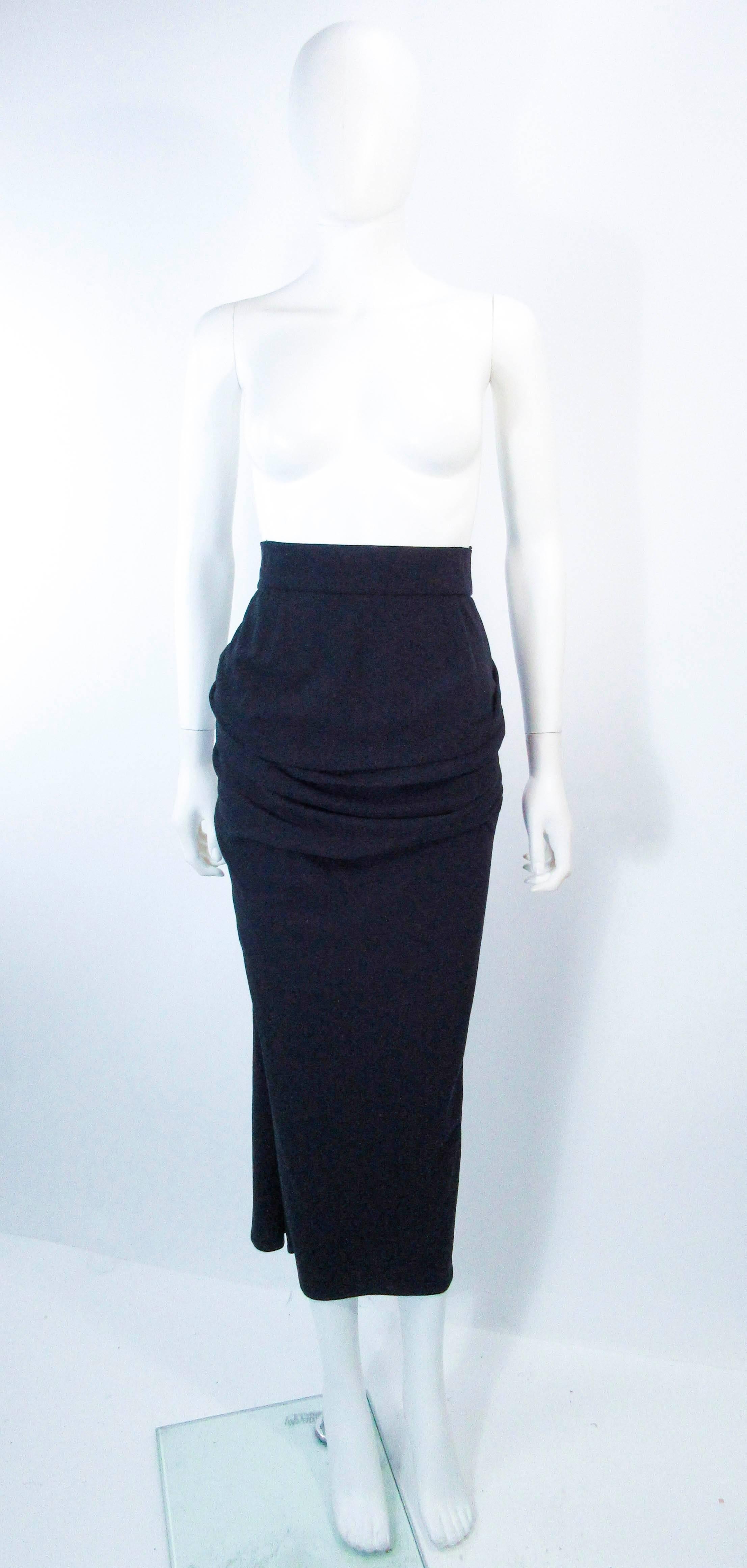 This vintage skirt is composed of a black silk matte jersey features a gorgeous gather with center back cascading drape. This is an absolutely striking design. In overall good vintage condition.

**Please cross-reference measurements for personal