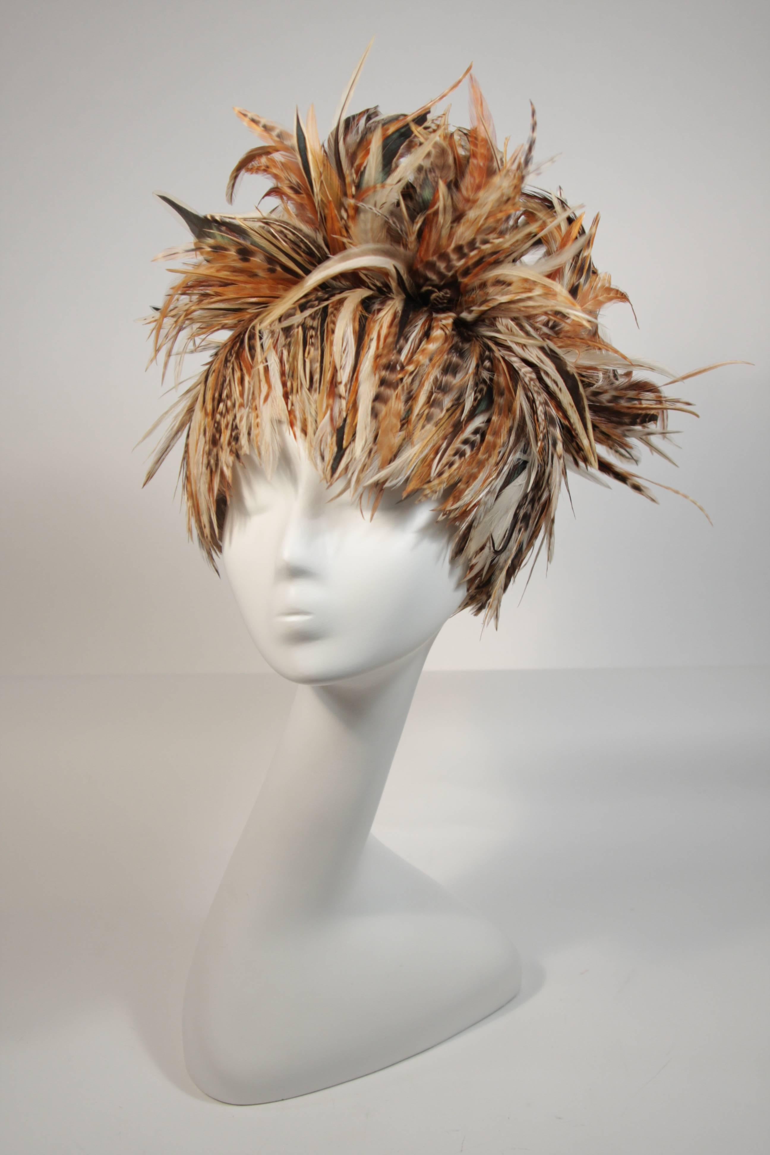 This Jack McConnell hat features a neutral color combination in hues of brown, oatmeal, and orange. This is an absolutely stellar hat in excellent condition. Such a burst of fantasy, an absolutely delectable design. Made in USA.

**Please