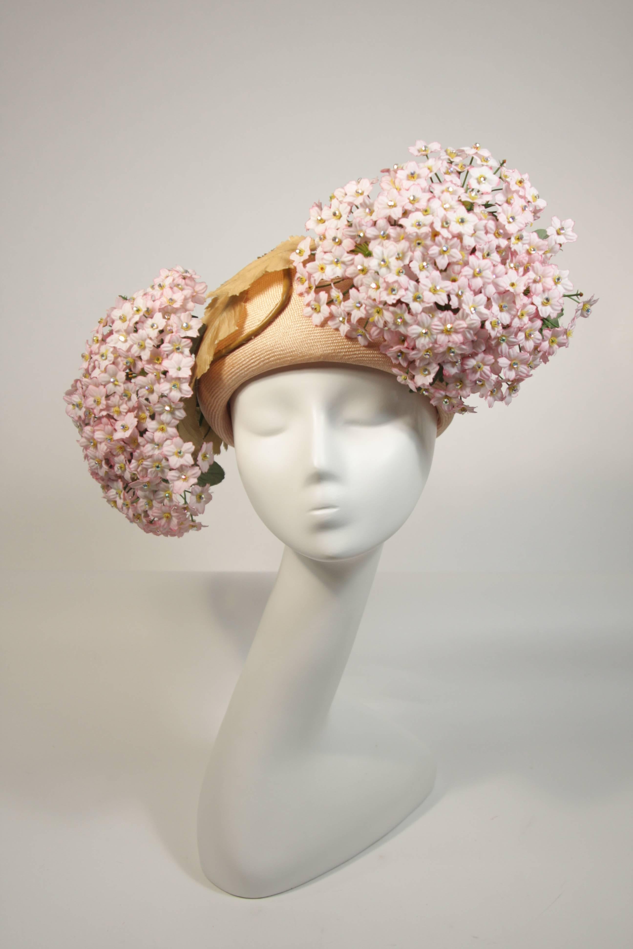 This Jack McConnell hat features a neutral base and two pink flower bouquets adorned with rhinestones. This is an absolutely stellar hat in excellent condition with original tags. Such an amazing design. Made in USA.

**Please cross-reference