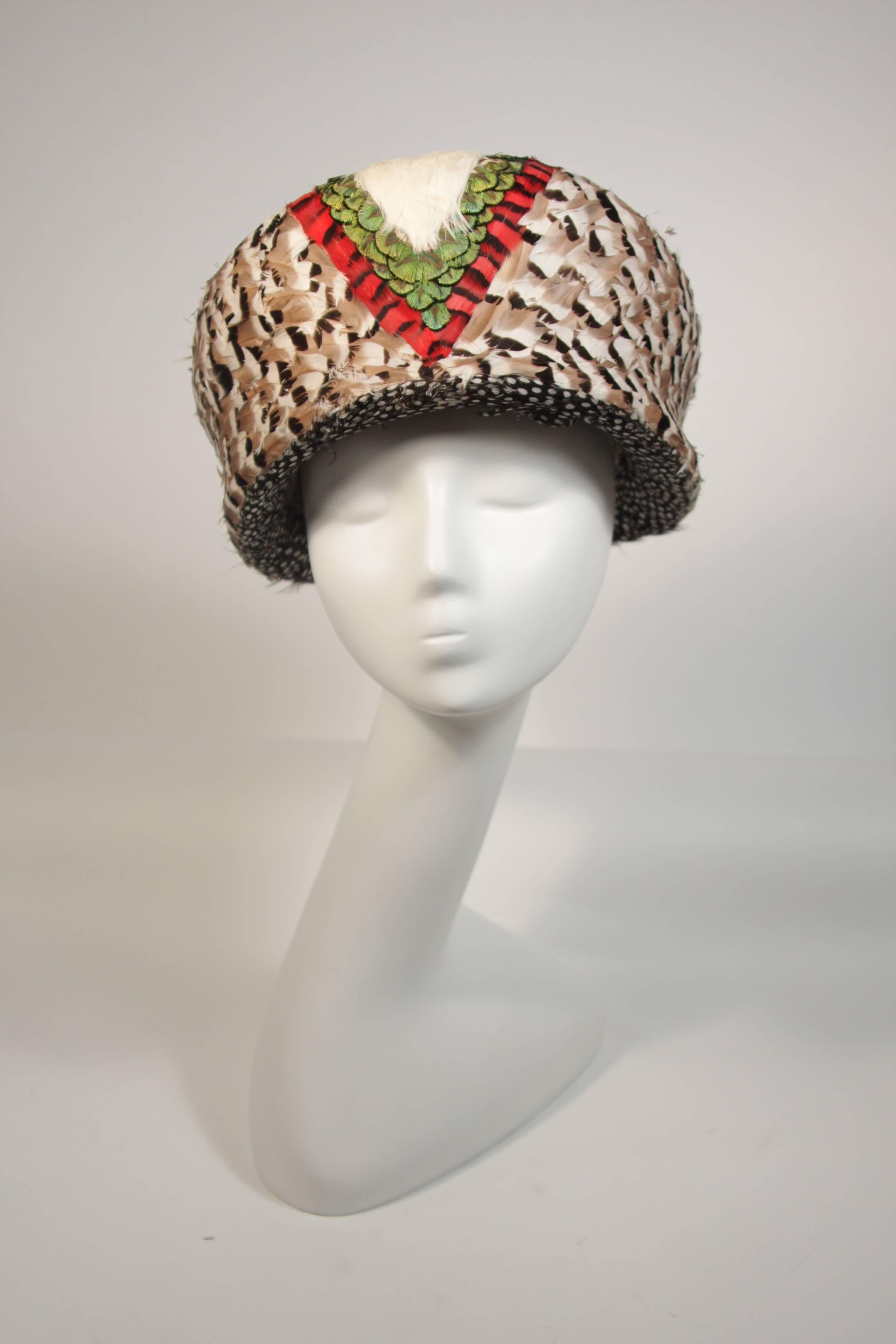 This Jack McConnell hat is composed of feathers in a geometric design and features a boxy shape . This is an absolutely stellar hat in excellent condition. A fantastic design. Made in USA.

**Please cross-reference measurements for personal