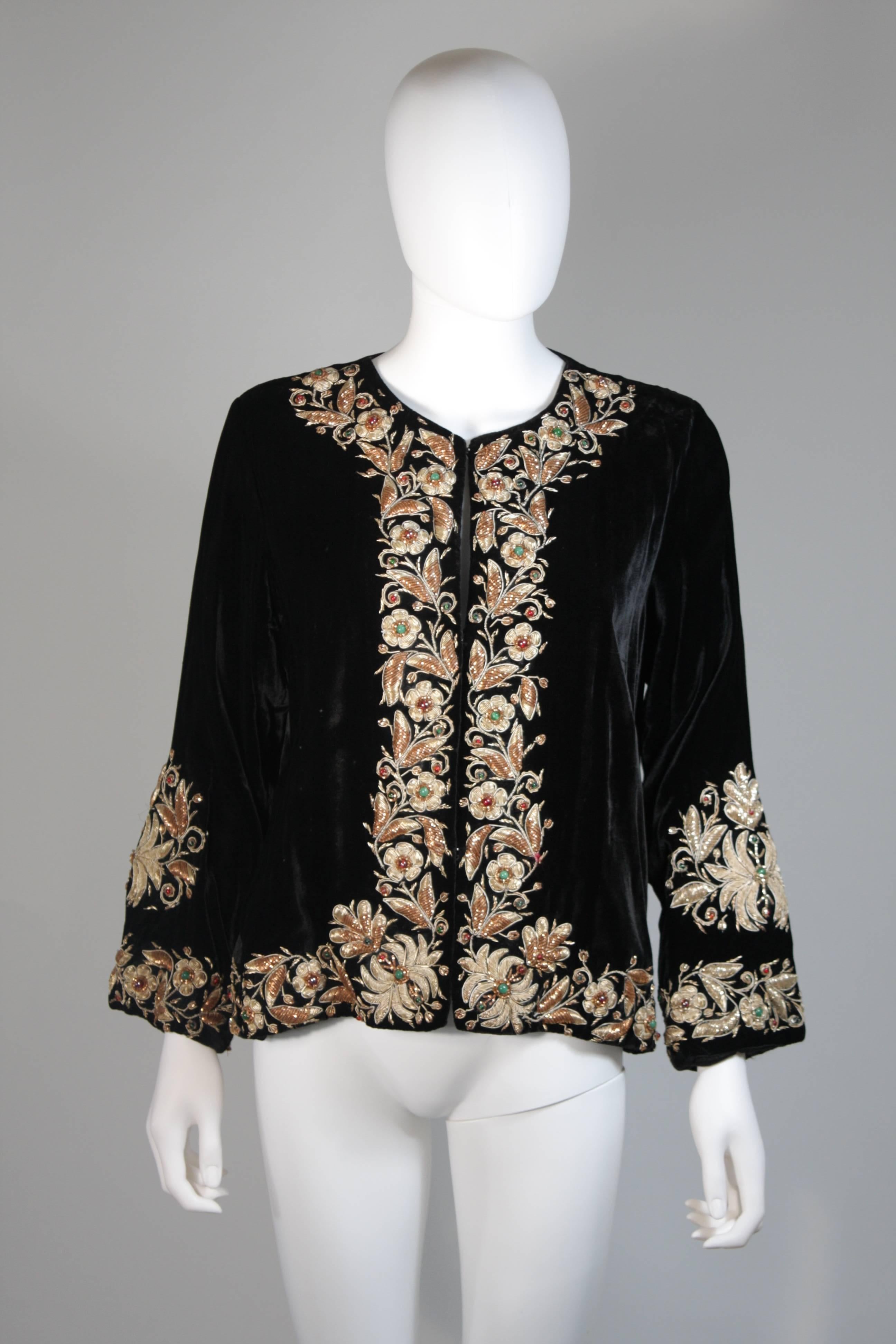 This vintage jacket is composed of a black embroidered velvet. There are center front closures. In excellent condition. 

**Please cross-reference measurements for personal accuracy. The size listed in the description box is an