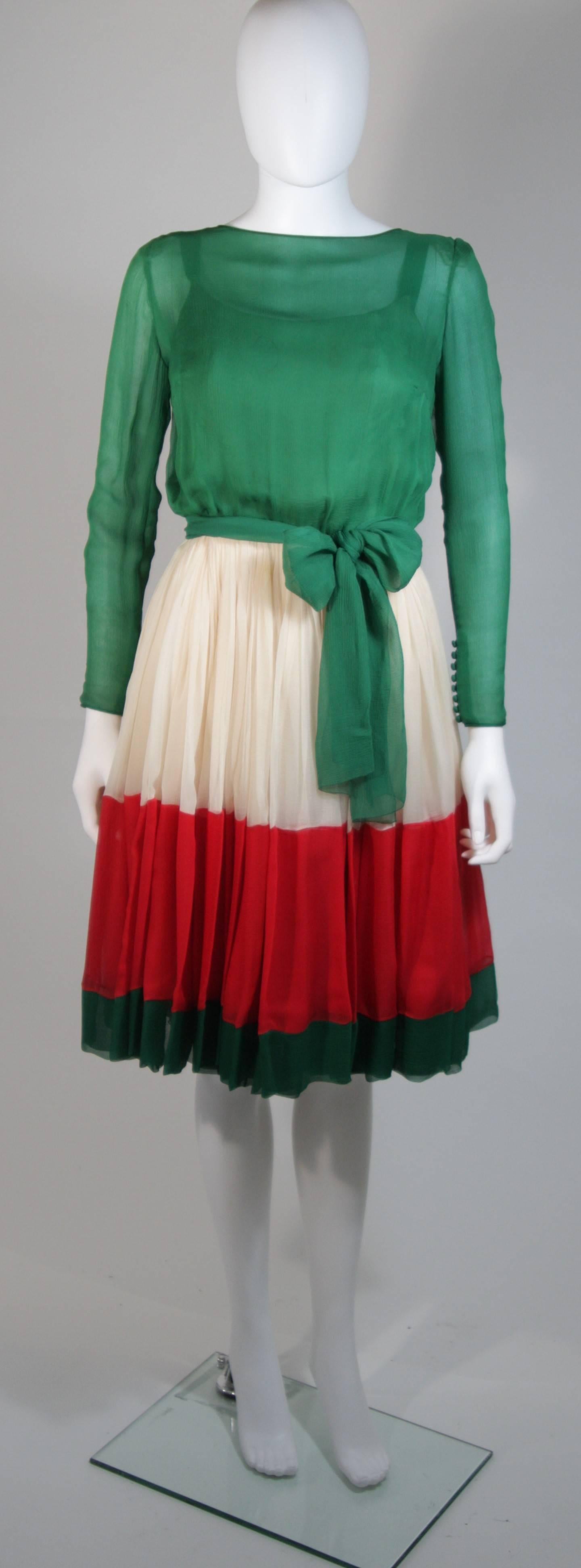 This Galanos cocktail dress is composed of a wonderful silk chiffon in green, cream, and red. The dress features center back button closures. In excellent condition. Made in USA.

**Please cross-reference measurements for personal accuracy. The