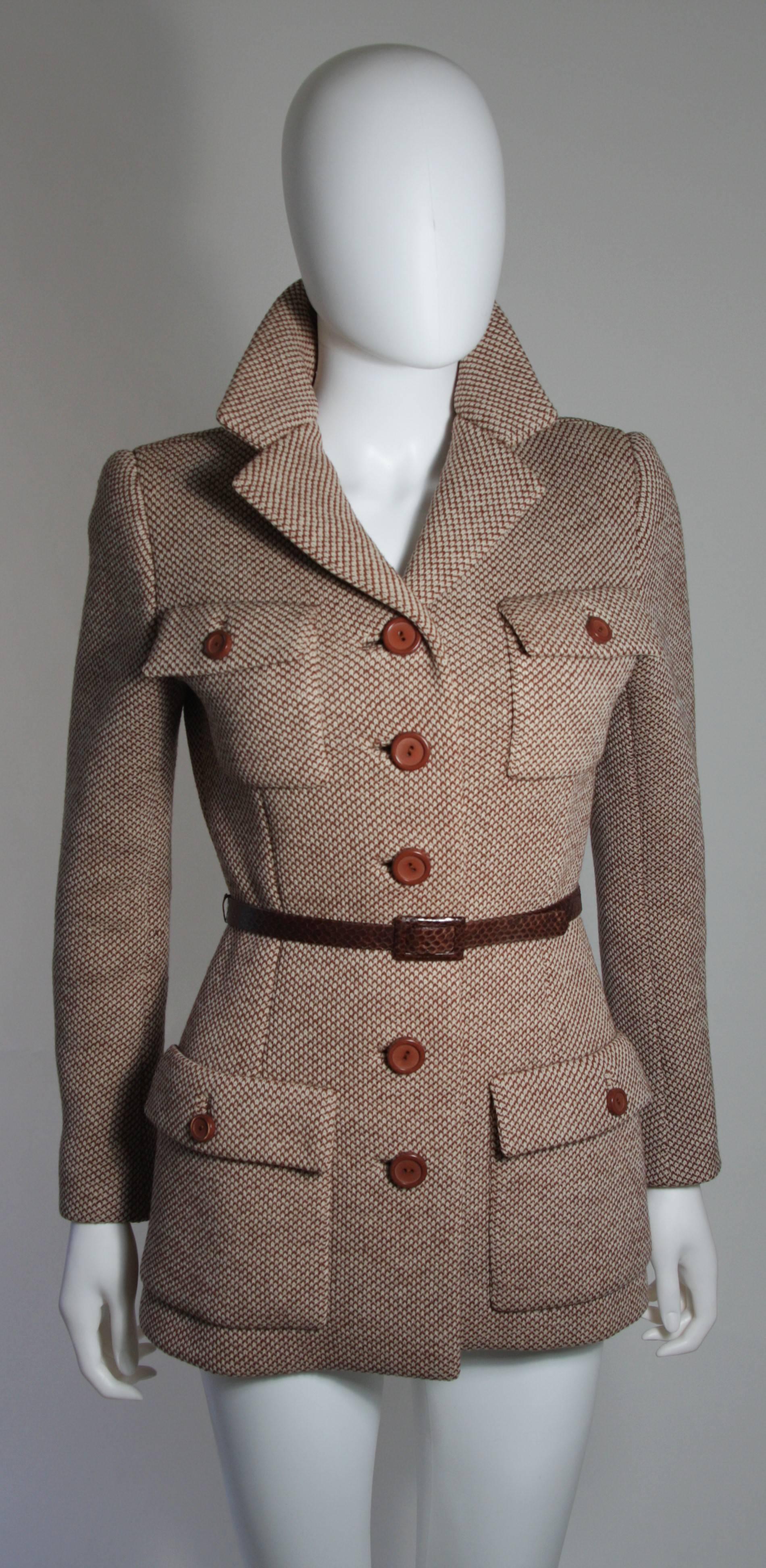 This Norell jacket is composed of a brown and white patterned wool. There are center buttons and pockets. Comes with brown snakeskin belt. In excellent condition. Made in USA.

**Please cross-reference measurements for personal accuracy. The size