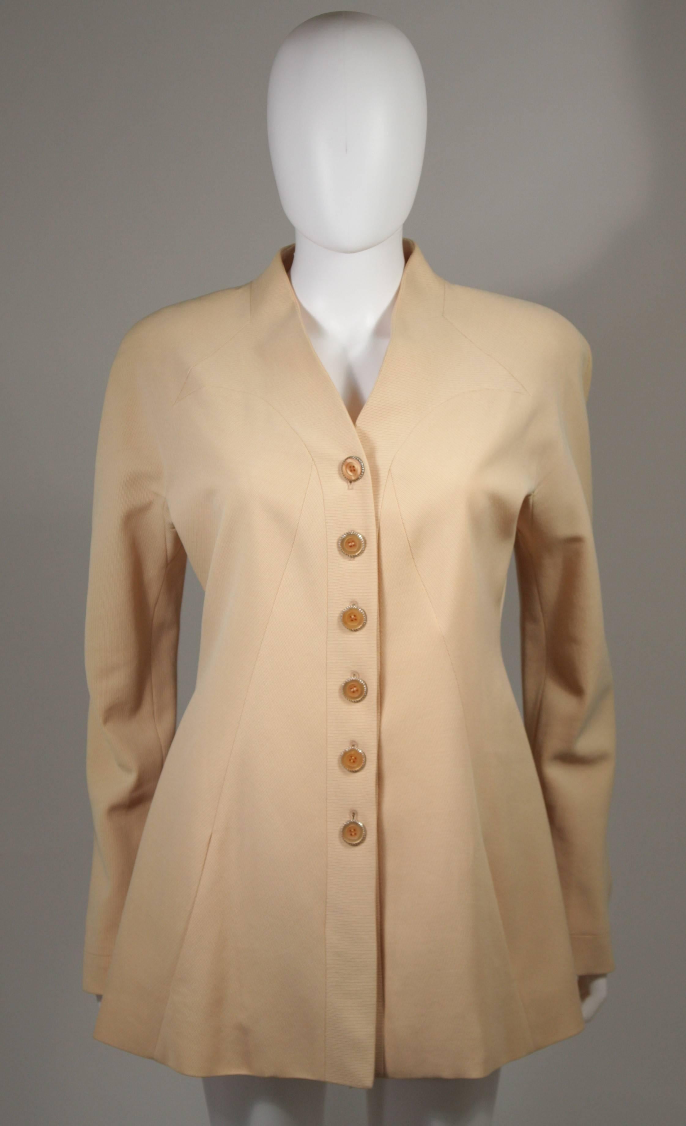 This Karl Lagerfield jacket is composed of an apricot hued fabric. There are center front button closures. In excellent condition. Made in France.

**Please cross-reference measurements for personal accuracy. The size listed in the description box