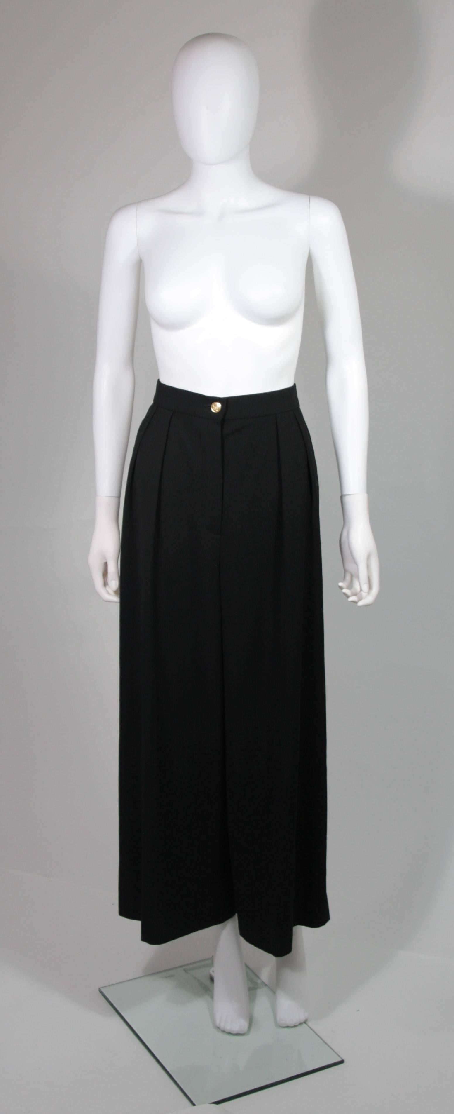 This Chanel design is available for viewing at our Beverly Hills Boutique. We offer a large selection of evening gowns and luxury garments. 

 These black trousers feature a wide leg with pleat detail. There is a zipper closure, side pockets, and