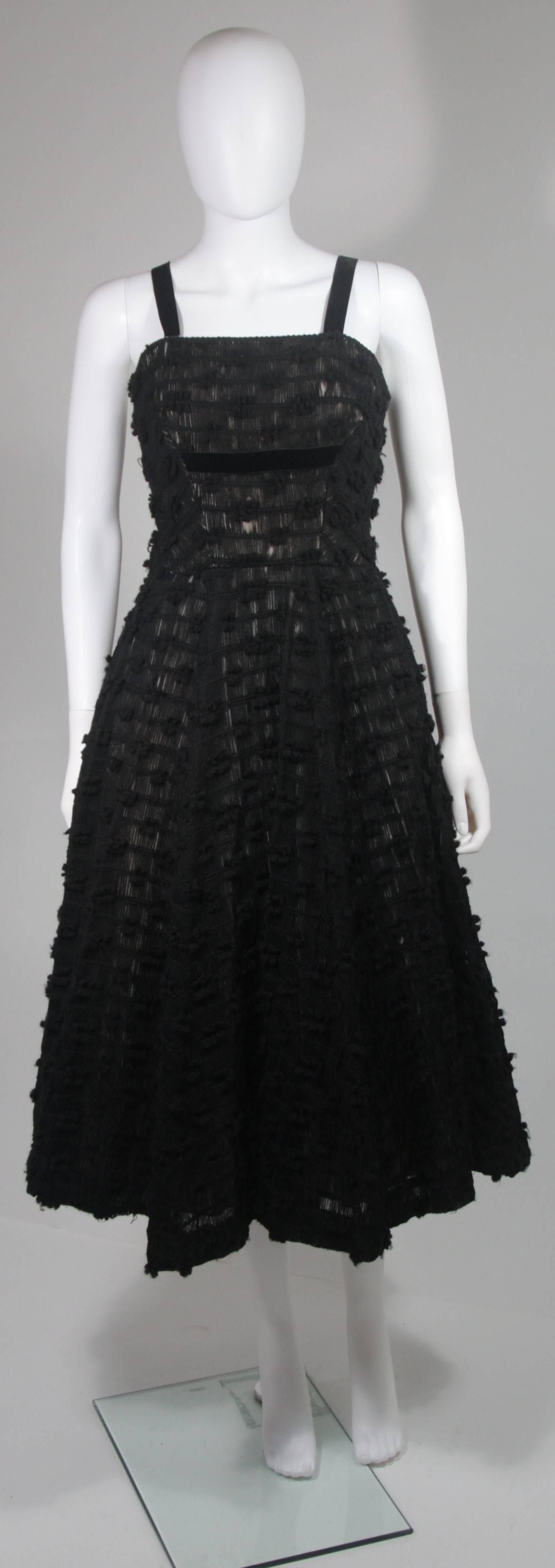 This Rappi cocktail dress is composed of a black knit and features a velvet ribbon accent. There is a zipper closure. This garment is in great vintage condition, excellent for design research, there are some areas of  wear on the knit. 

**Please