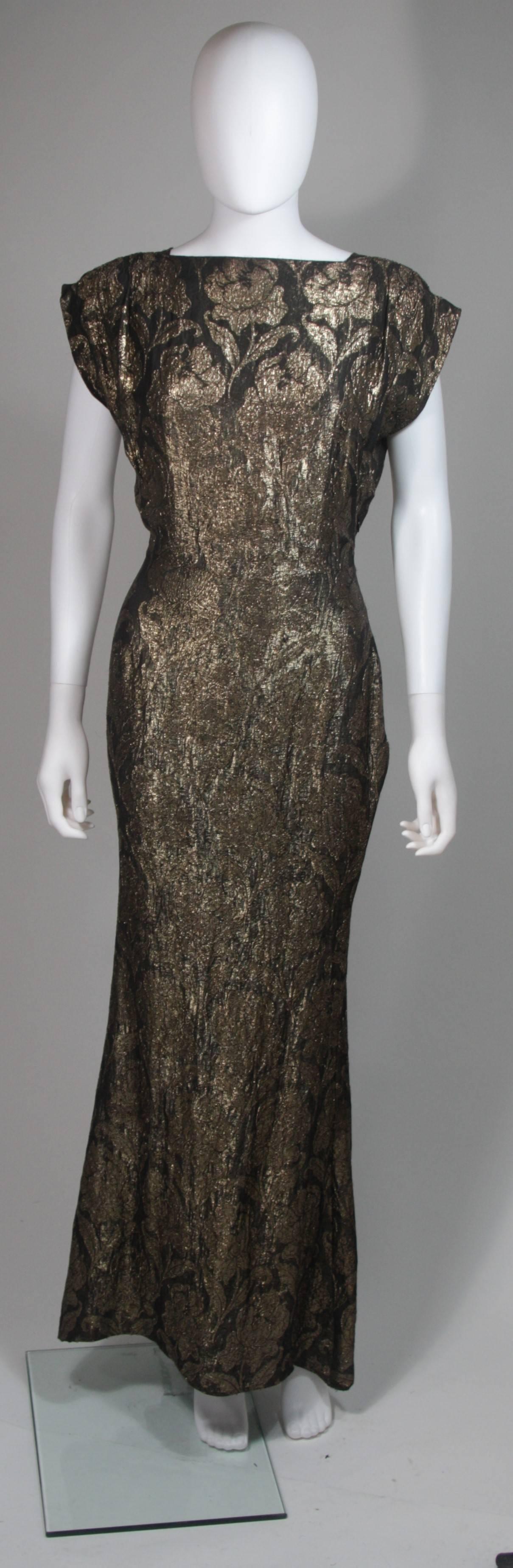 This Bullocks gown is composed of a gold and black silk lame. The back features a plunge design with godets that fall from the waist to hem for add flare. This is an absolutely stunning and rare design. There is a side zipper closure with hook and