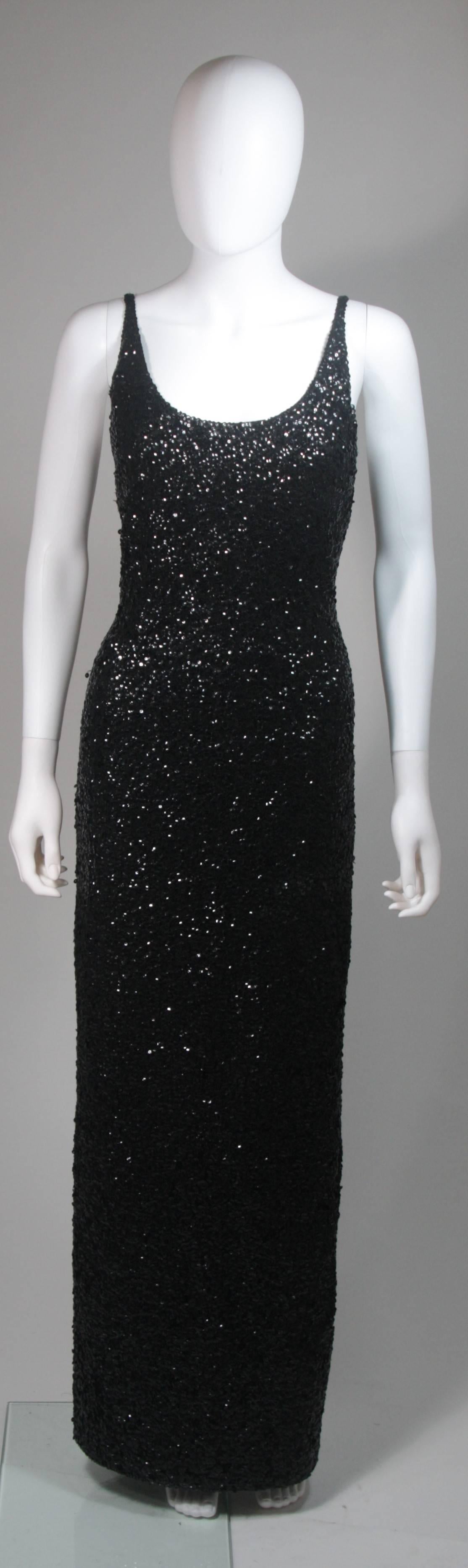 This Gene Shelly gown is composed of a black stretch knit wool with hand applique black sequins throughout. This stunning design strap design gown has a center back zipper. Made in Hong Kong. In excellent vintage condition.

**Please