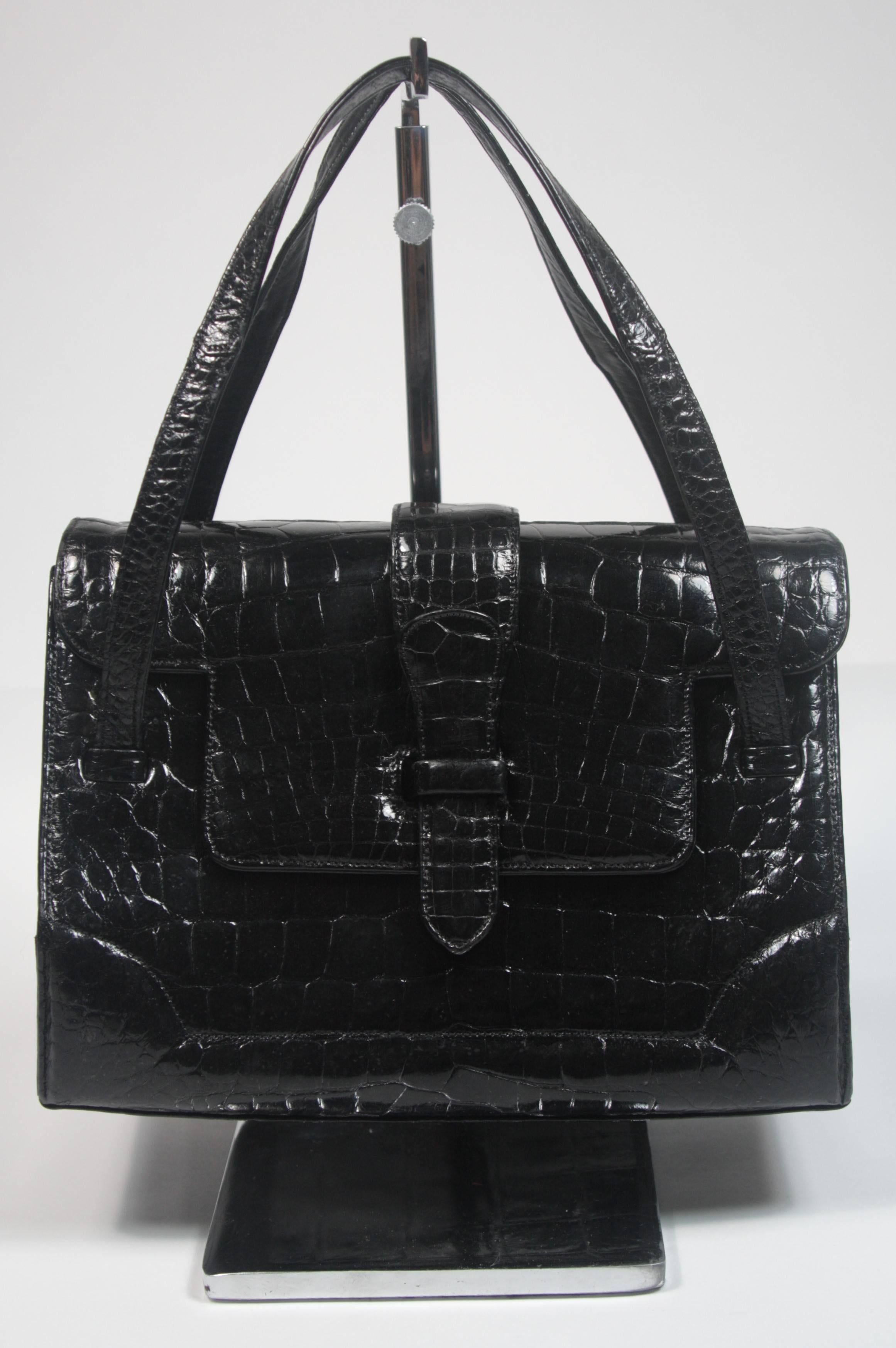 This Lucille De Paris handbag is composed of a striking black Alligator. It features multiple interior compartments, the original mirror and coin purse. In excellent condition. 
Made in the United States. 

**Please cross-reference measurements for