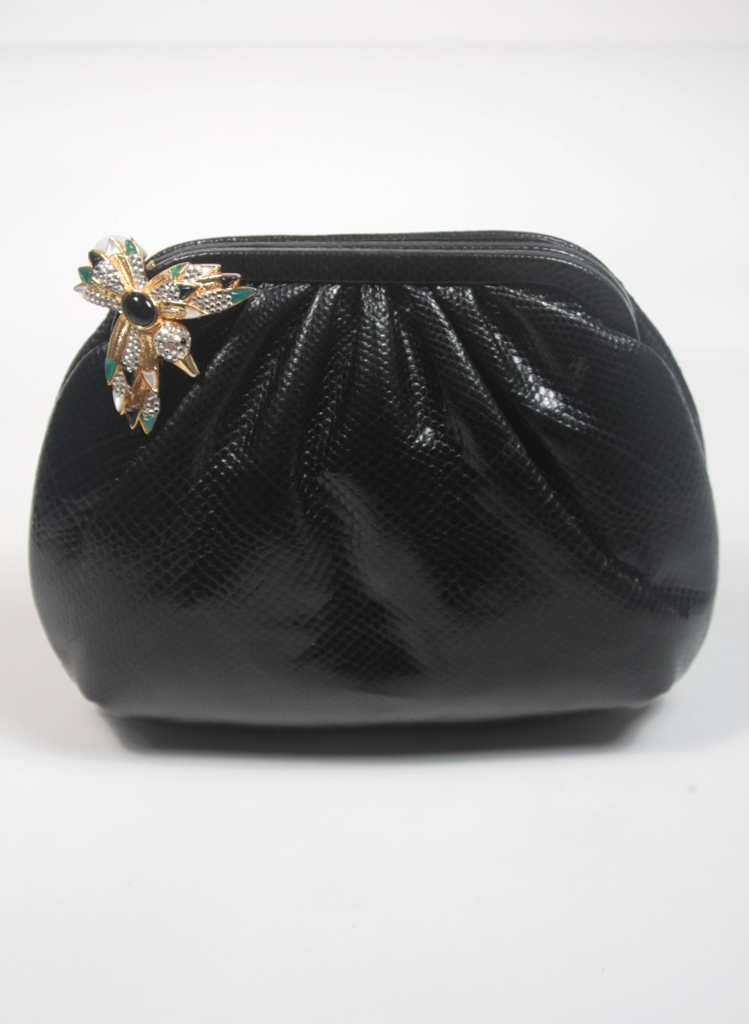This Lucille De Paris handbag is composed of a black lizard and features a bejeweled hummingbird clasp. It features an interior compartment, the original mirror, comb, and coin purse. In excellent condition. Made in France. 

**Please