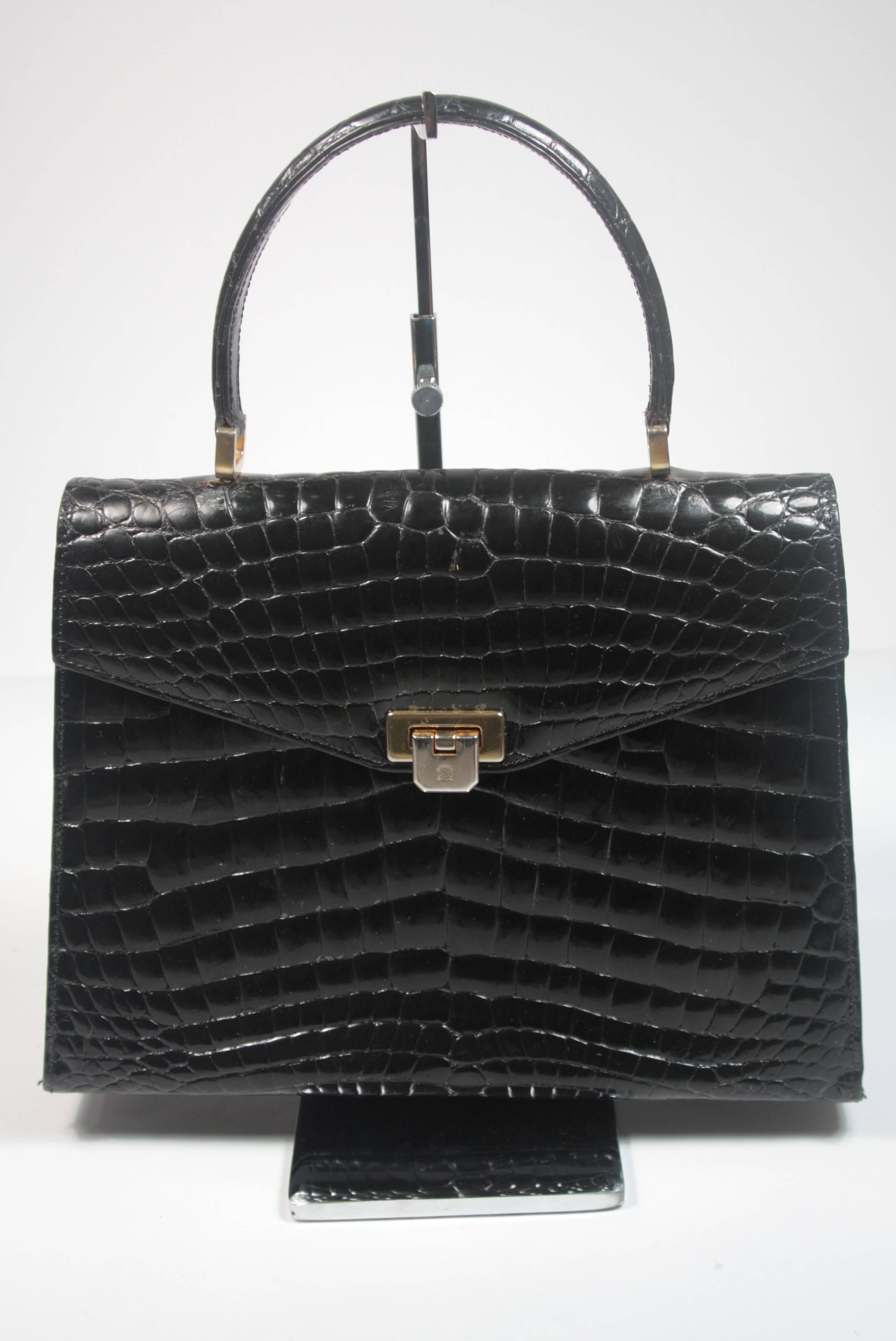 This Amir Italy handbag is composed of black Crocodile. It features multiple interior compartments and a back slot pocket. In excellent vintage condition. Made in Italy. 

**Please cross-reference measurements for personal accuracy.