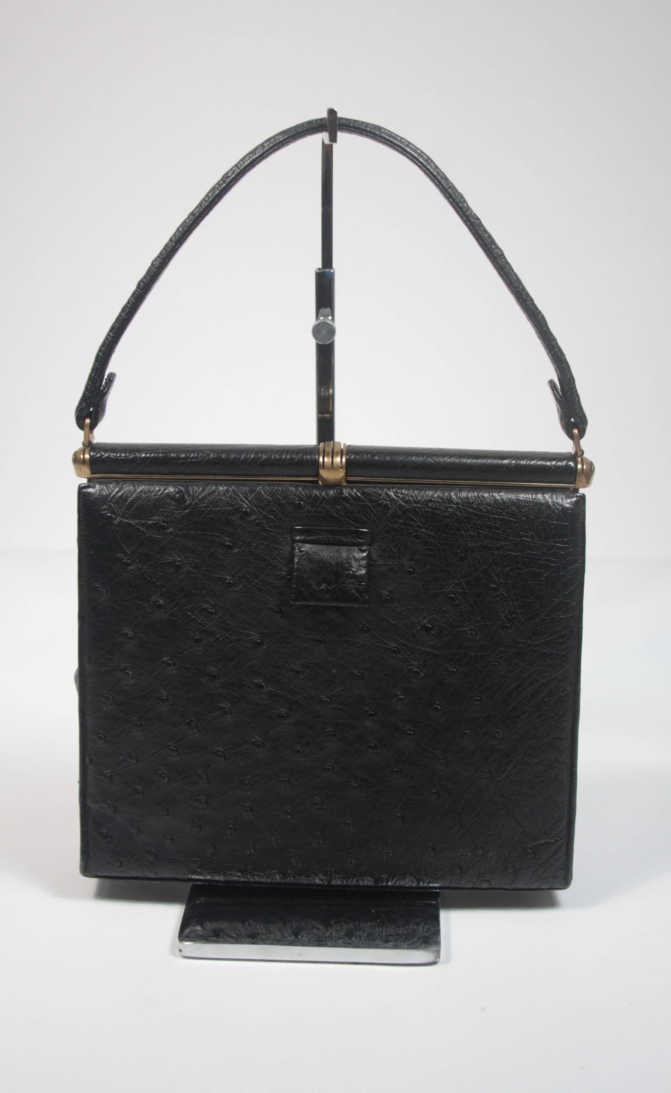 This Lucille De Paris handbag is composed of black ostrich with gold tone hardware. It features multiple interior compartments and comes with the original mirror. In excellent vintage condition. Made in France. 

**Please cross-reference