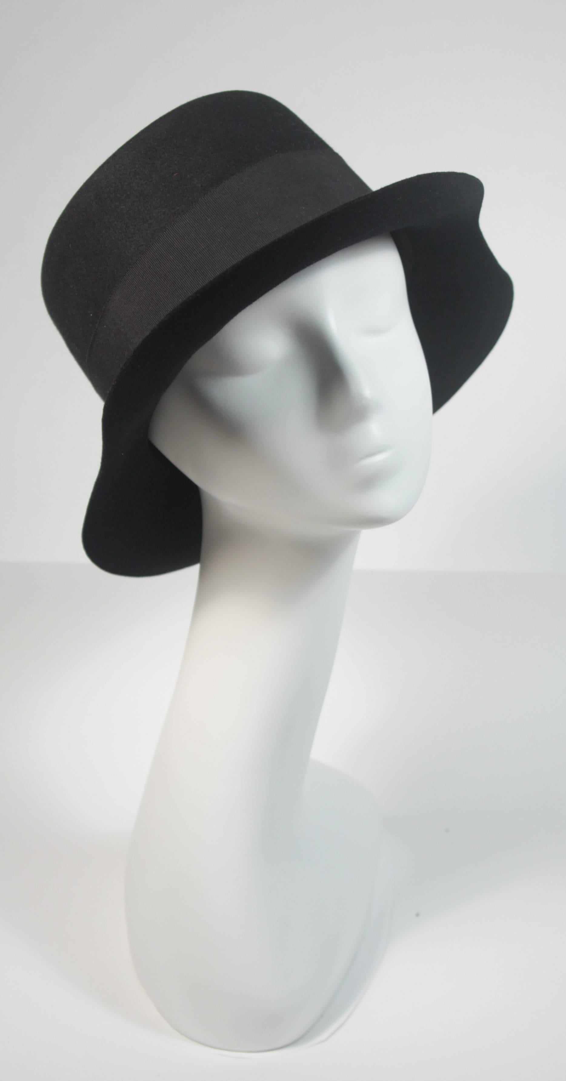 This Yves Saint Laurent Rive Gauche design is available for viewing at our Beverly Hills Boutique. We offer a large selection of evening gowns and luxury garments. 

 This hat is composed of a black wool felt and features a curved brim. In