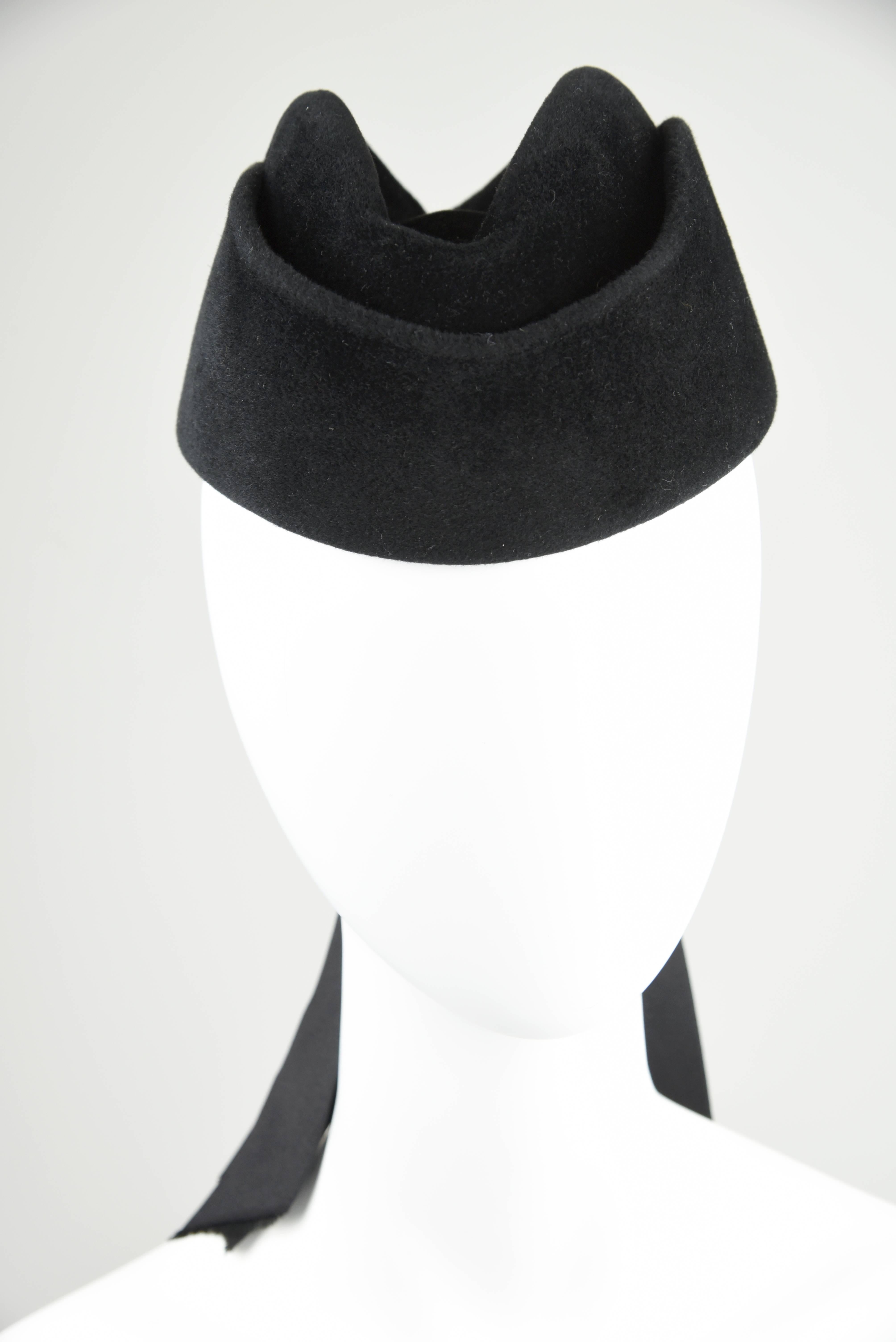 A most elegant and sophisticated hat, featured in the 1988/1989 Fall Winter 32 page Chanel Catalogue which is included with the hat. The Satin Bow is double faced ribbon with a length from the top of the bow to the end of the ribbons of 14 inches.