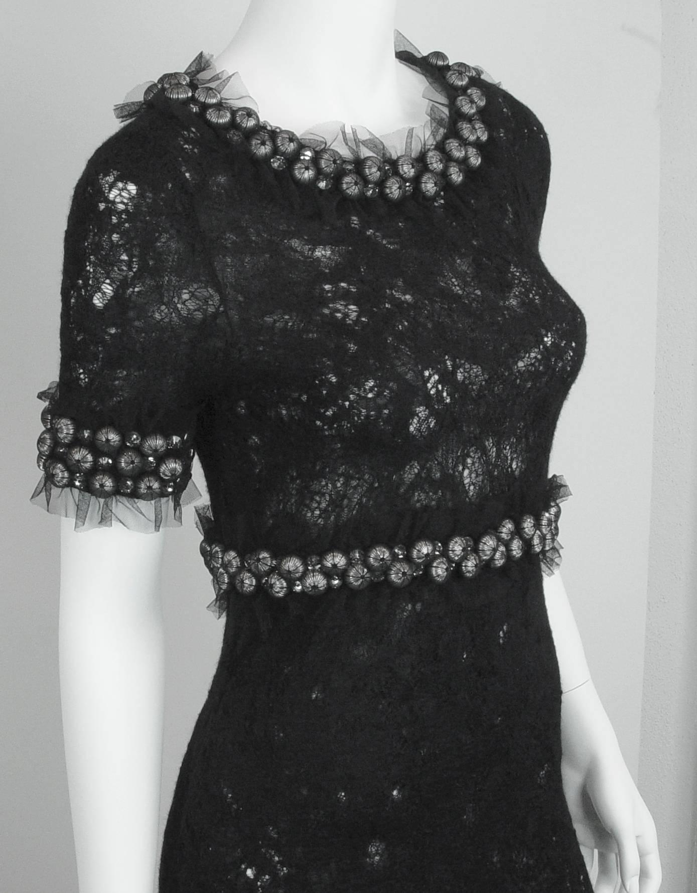 Elegant Chanel evening gown of three dimension black stretchy see-through lace.  Hand made Lesage details include 3/8" Rhinestones and 5/8" silver beads encased in silk net and net ruffles at the neck, waist and bottom of sleeves. This