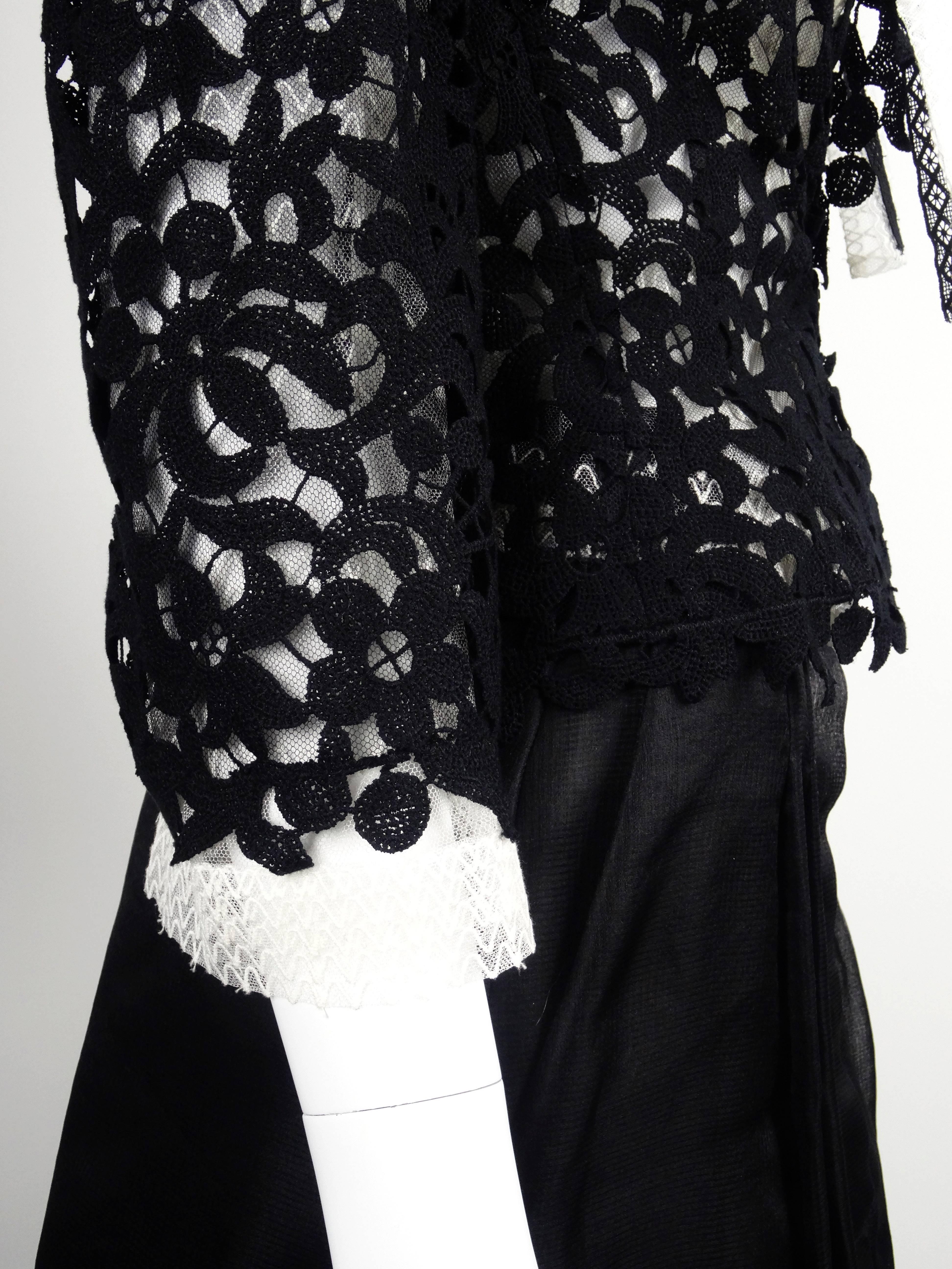 A black lace jacket and white cotton/silk/nylon lace blouse, both from the Lesage Paris venerated embroidery studio are paired by Chanel with a black silk 3/4 skirt for a rich 3-piece ensemble.  The lower third of the skirt is unlined for