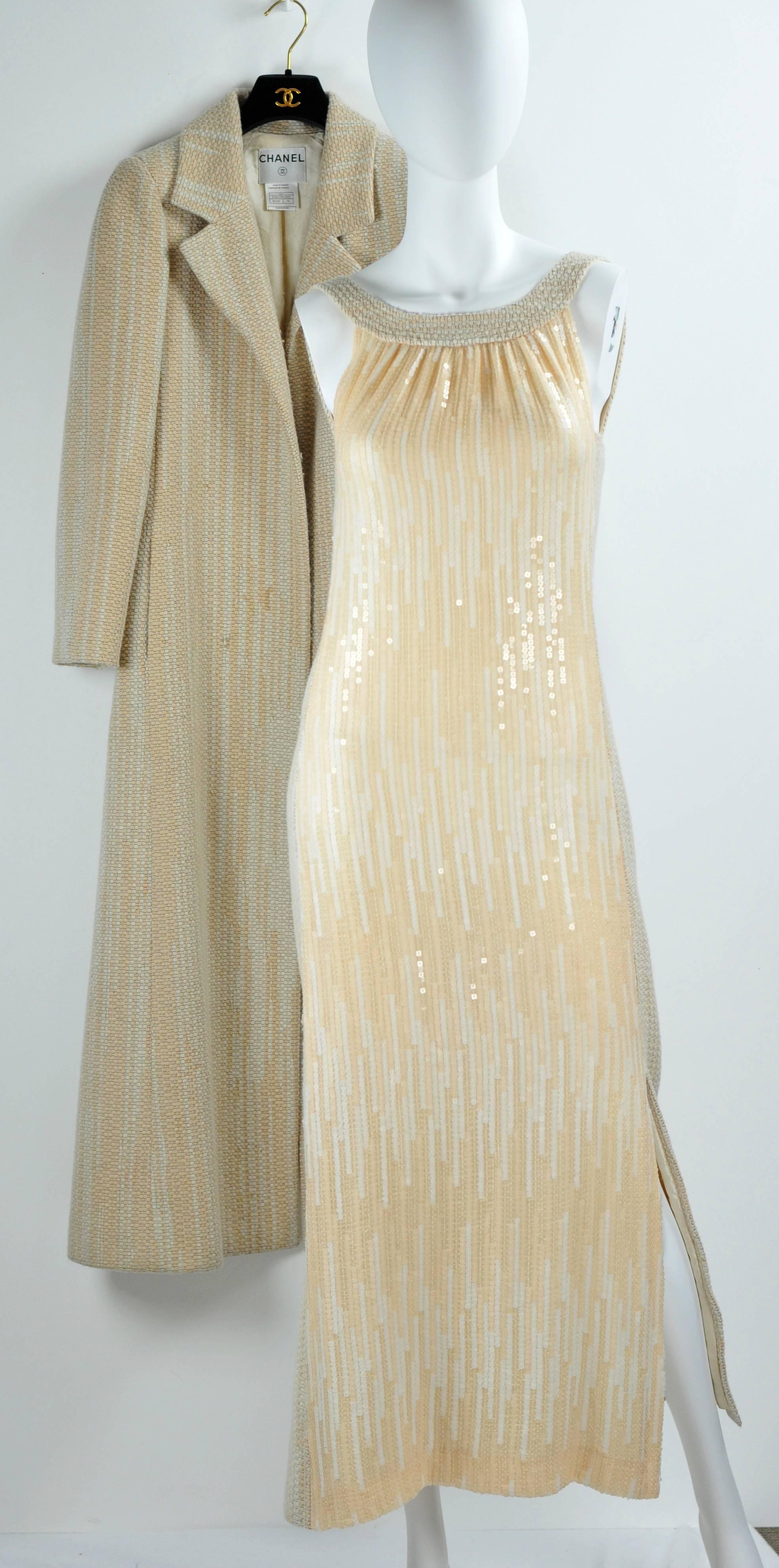 A luscious Chanel ensemble from Fall 2001 includes a full length coat and a matching full length sleeveless dress.  The entire front of the dress is covered with solid sequins from collar to hem and full width.  It has a subtle vertical pattern of