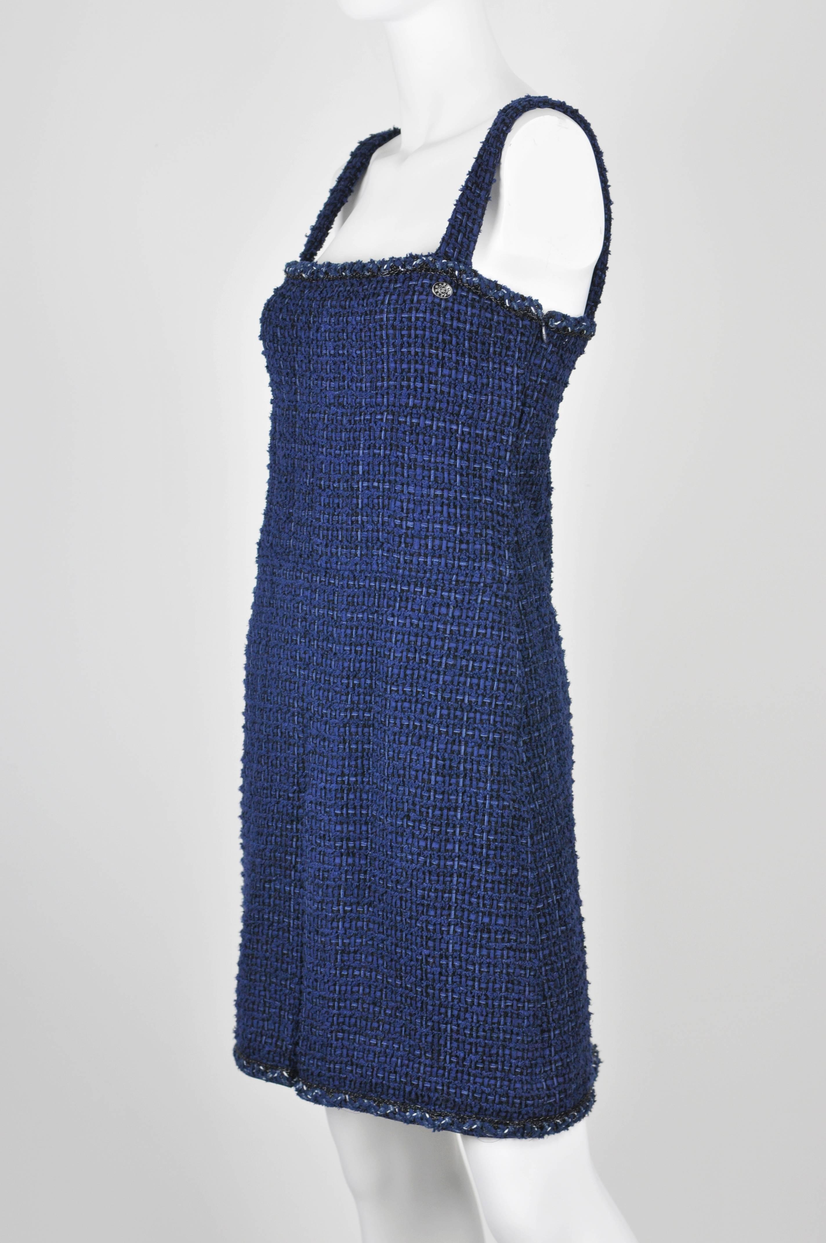  A great Chanel dress with gorgeous dimensional weave fabric of 90% cotton and 10% nylon with multi blue and black threads.  Edging is braided threads with black shiny threads for sparkle at top edge and hemline with a perky inverted plead at front
