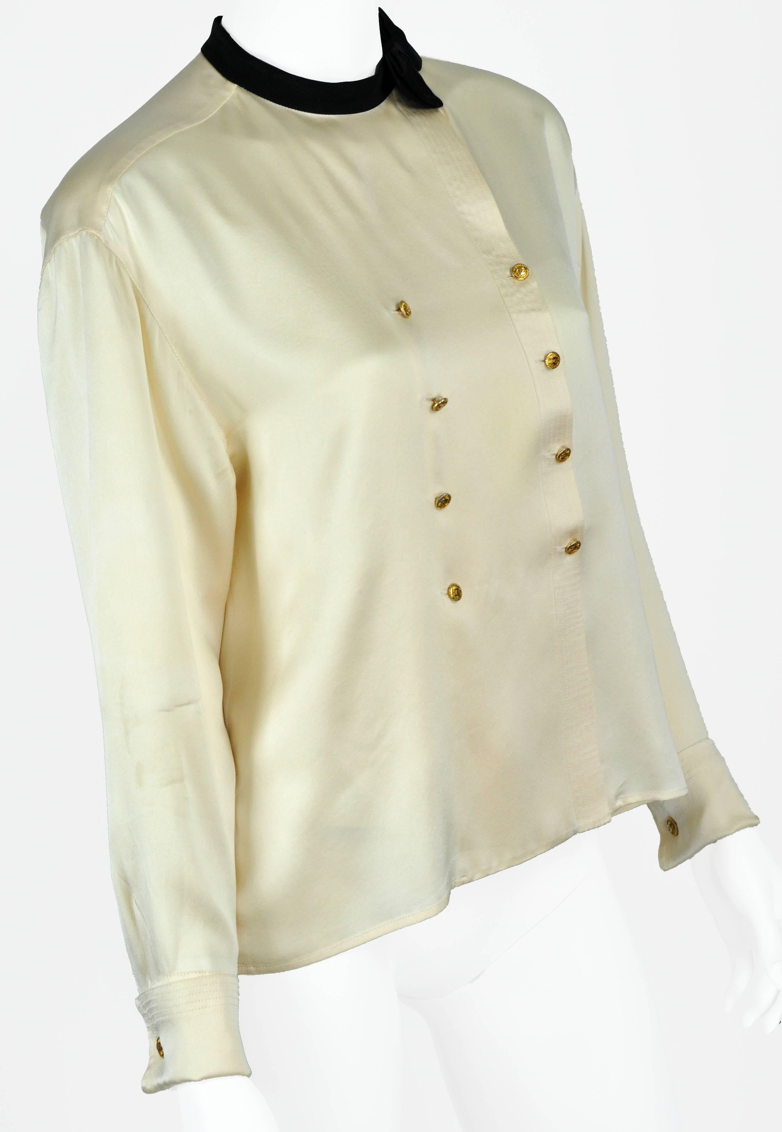 It is a miracle that a Vintage white satin Chanel blouse is in like new condition complete with matching cuff links. The killer part is the perfectly executed black satin bow at the neck and confirms that it is indeed of Chanel Boutique label