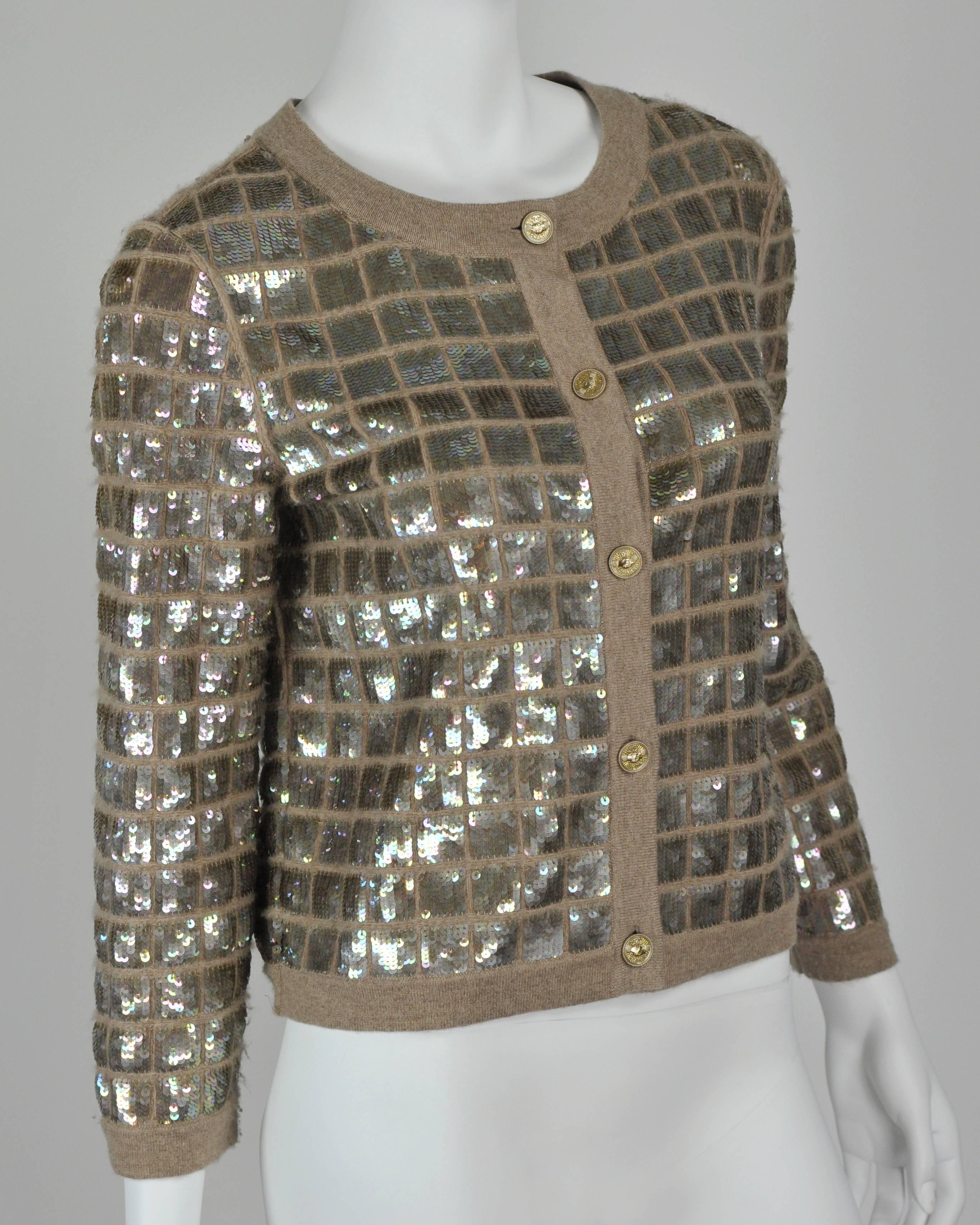 A great go-with-anything cardigan made of Chanel's famous Scottish cashmere and exceptional sequin detailing.  Sequins are 100% polyester.  Extra yarn and button are included. Like new.
Measurements:  Height 20", Bust 36", Wist