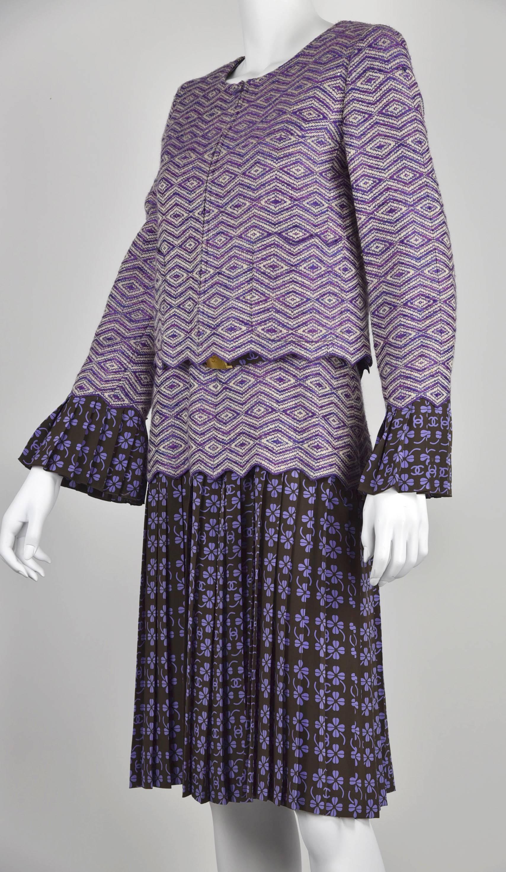 This is an unusual Chanel dress ensemble with a beautiful stand alone pleated skirt dress with belt and a woven pattern wool jacket with matching silk print pleated sleeves. There are not many Chanel ensembles like this with such complex design