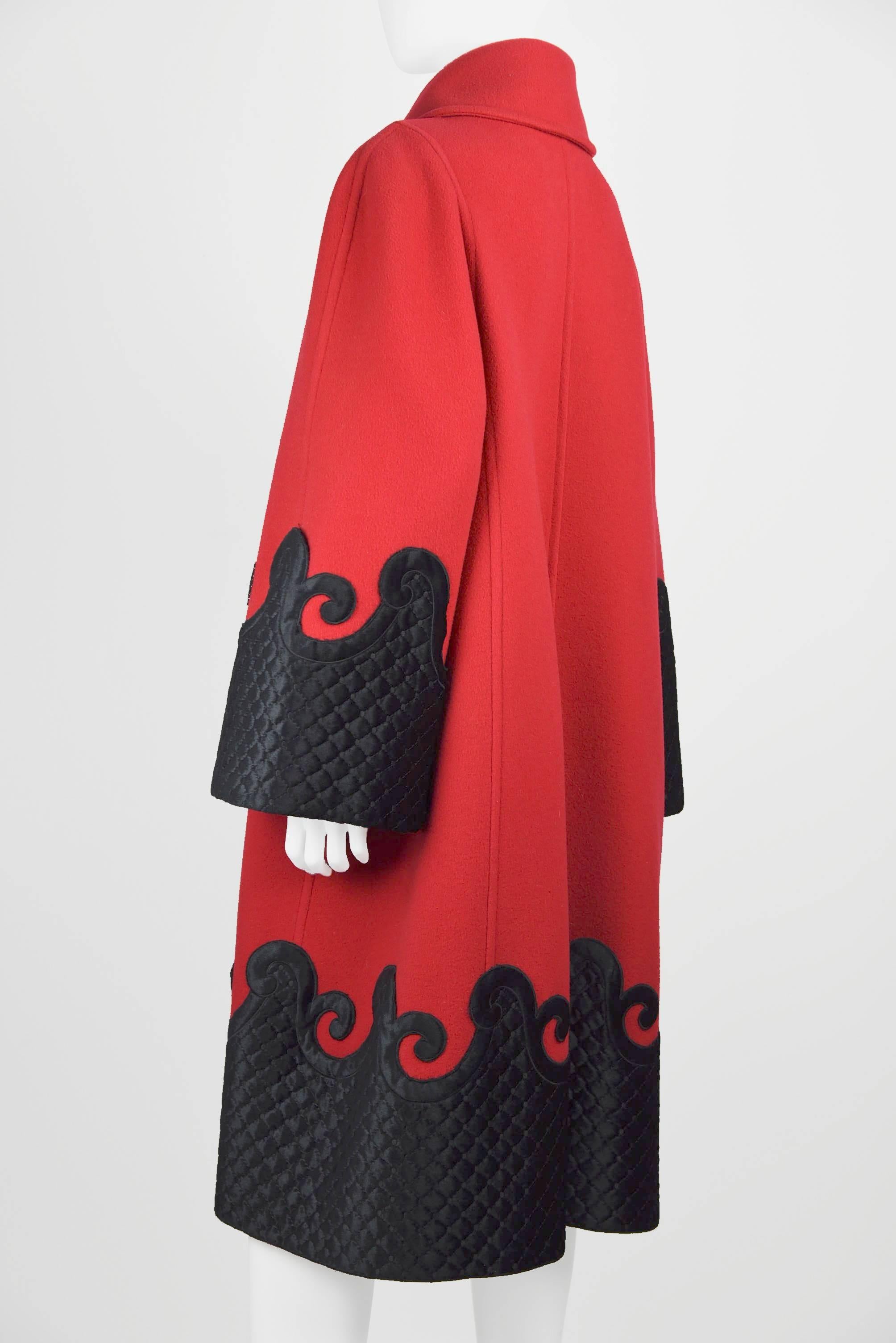 Elegant Red Evening Coat with black "quilted" applied designs to sleeves and bottom of coat.  Measurements: Height 42.75", Sleeves from shoulder to end 24 1/2", Hem circumference 66".  Fabric:  40% Rayon, 30% Polimid, 30%