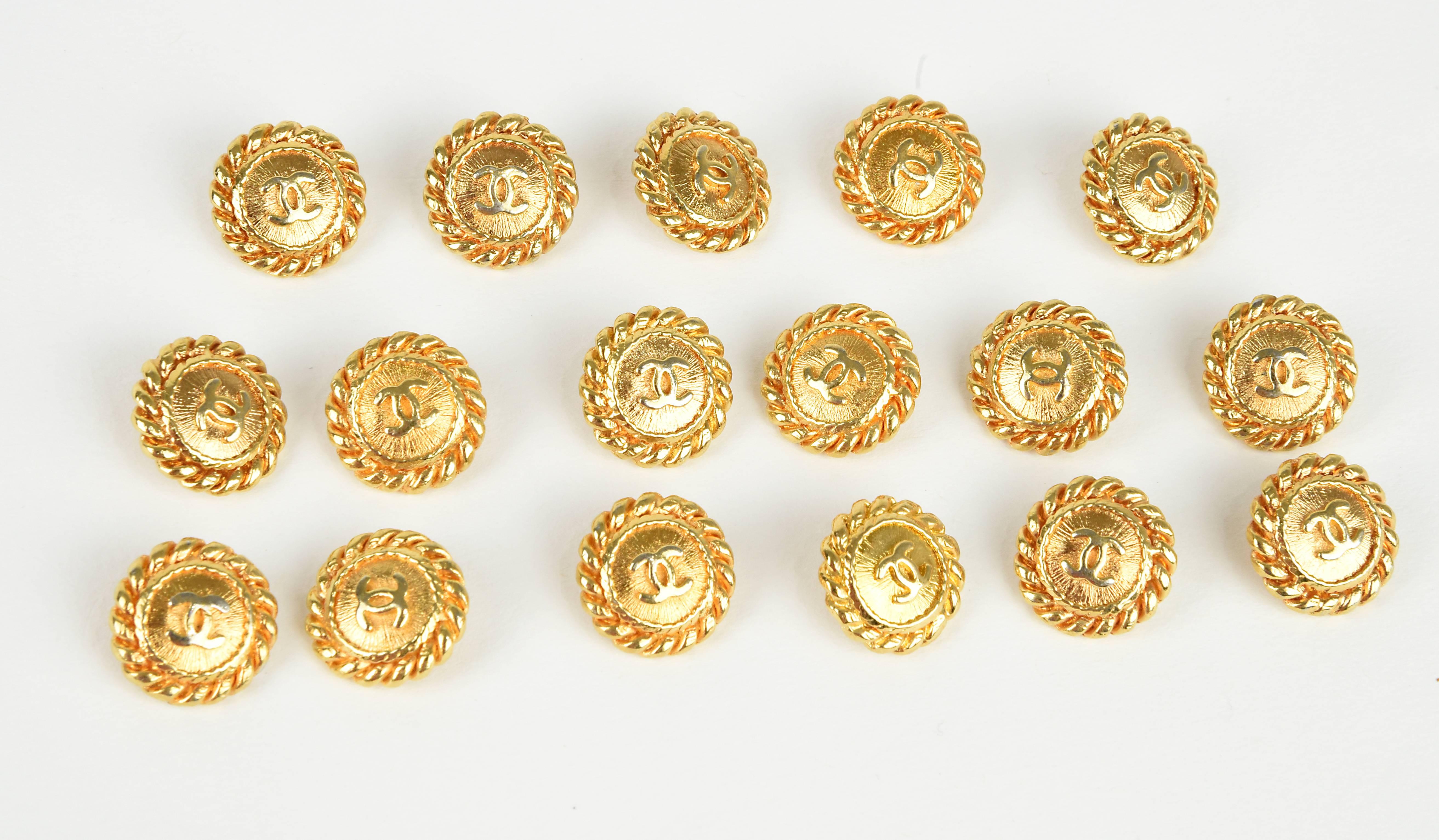 Chanel design collections are always defined by the buttons.  Here we have one of the most classical designs of a sunburst background behind raised CC's and surrounded by a lovely rope design edge. Unusual collection of 17 buttons.  Measurement: 