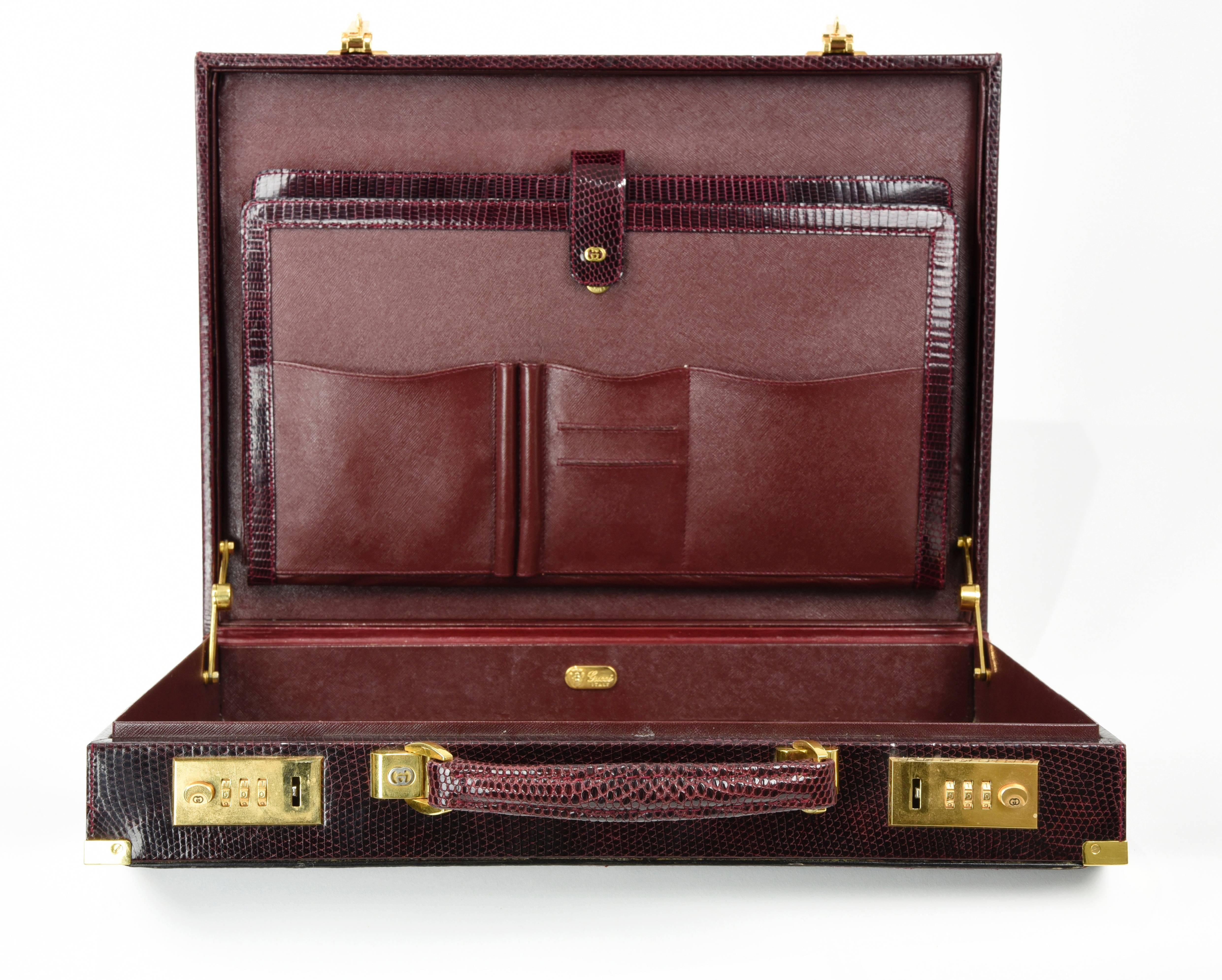A most handsome substantial (6 pounds) lizard briefcase with gorgeous gold hardware including 4 corner guards, heavy duty hinges,  handle hardware,and locking mechanism.  Inside has two14.5" pouches and 5 compartments for pens, cards and note