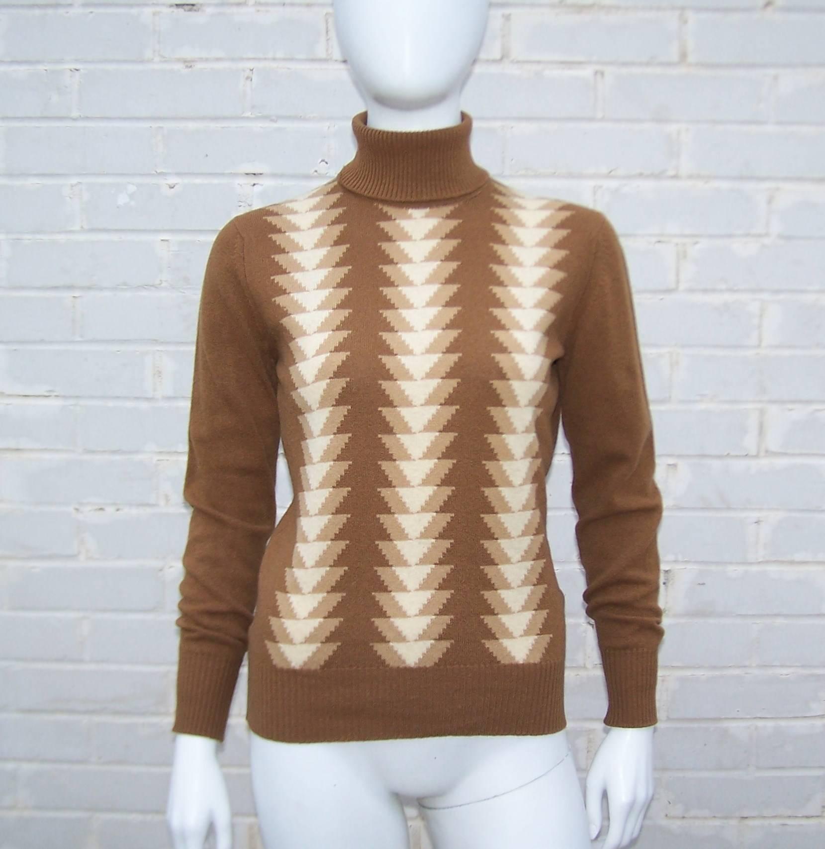 Jaeger has been making classic clothing since the turn of the 20th century.  This turtleneck sweater in light brown with a graphic arrowhead print in lighter brown and creme colors is made from high quality lambswool.  Vintage Jaeger clothing often