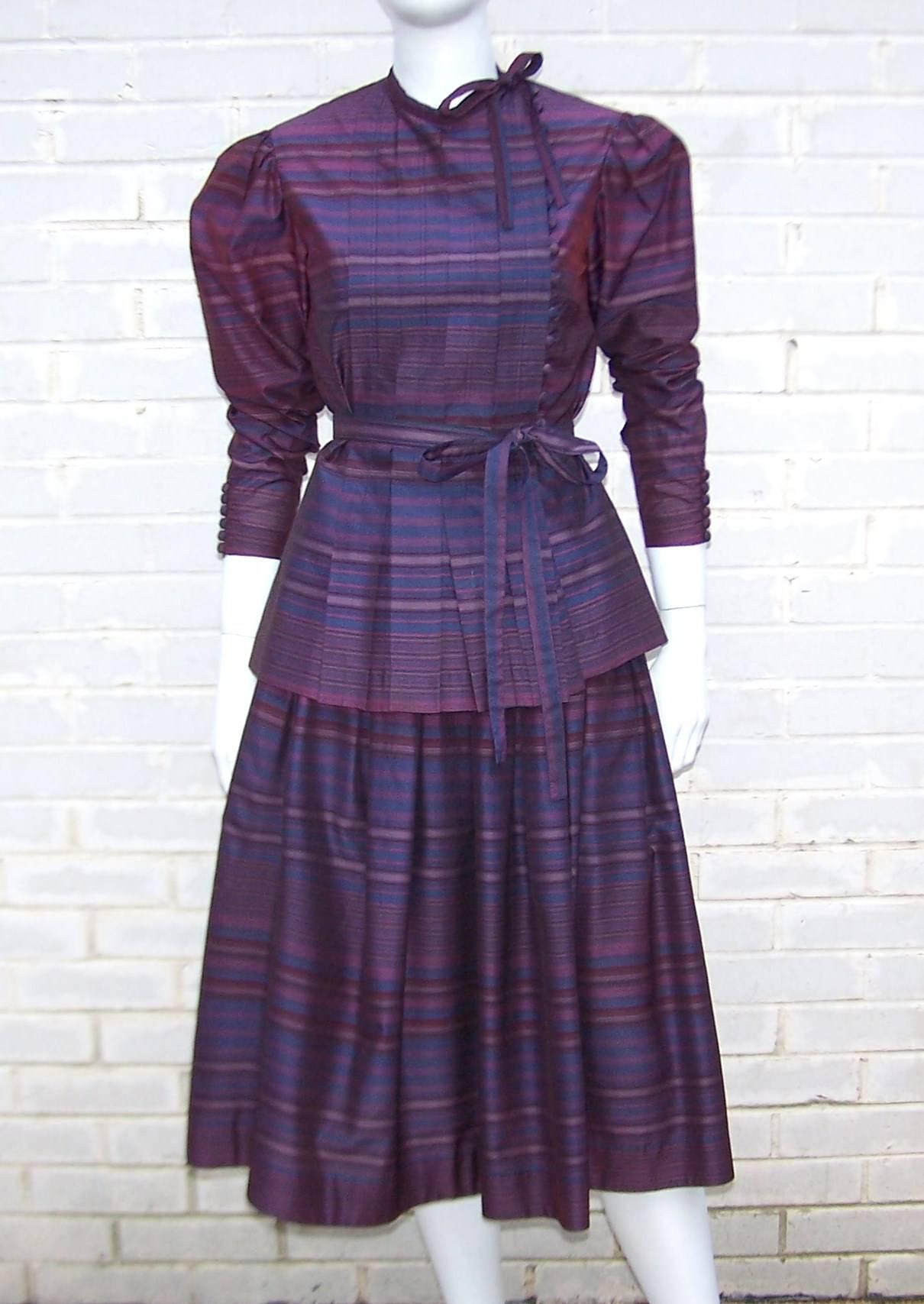The detail on this 2-piece dress ensemble is up to Pearl and Albert Nipon's standards for providing feminine and stylish attire.  The top has an asymmetrical tie at the neck with a brilliant row of buttons at the front and the cuffs.  Modest