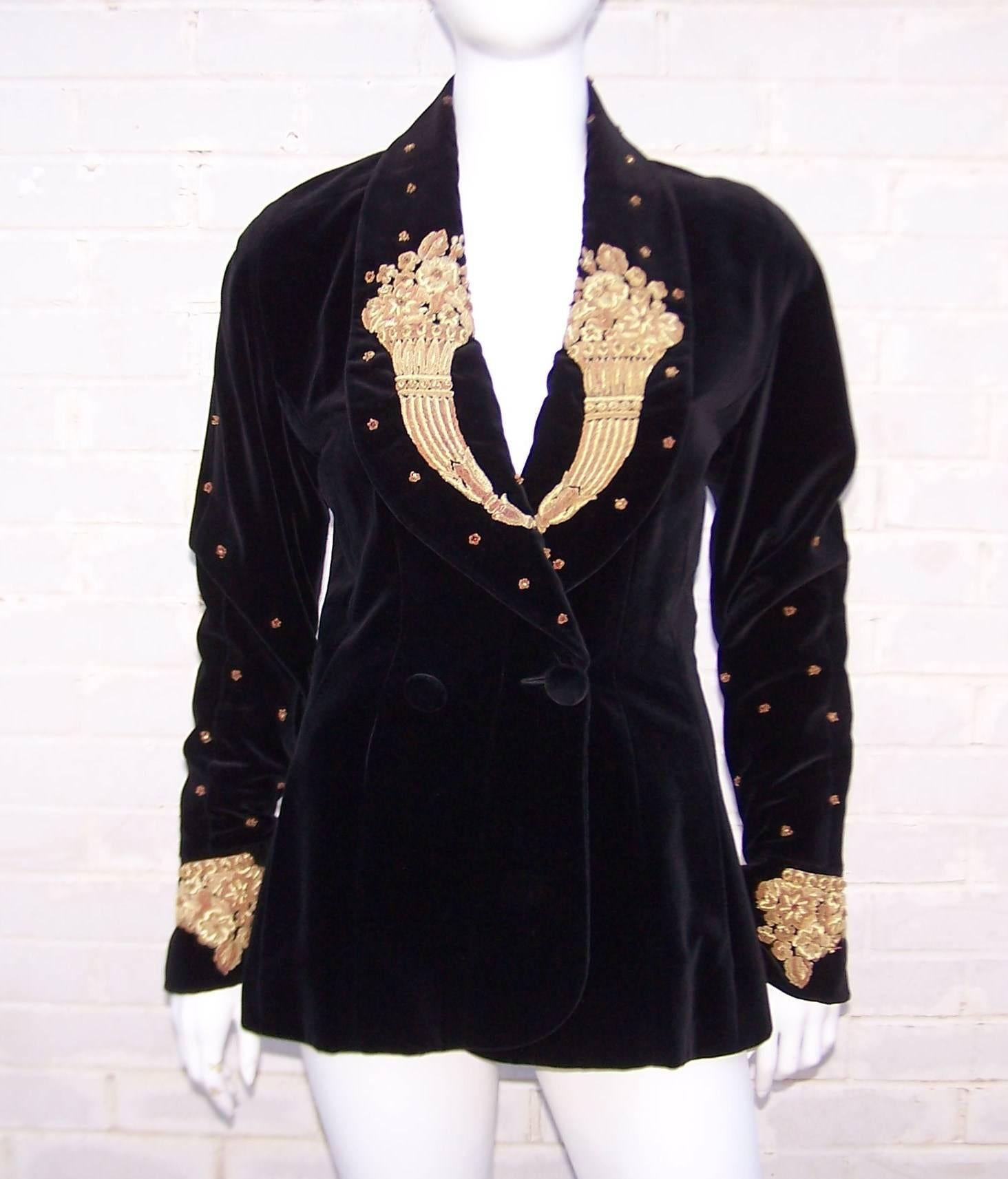 Luxury abounds in this black velvet jacket by Karl Lagerfeld.  The raglan sleeved double breasted construction has a relaxed smoking jacket style complete with front pockets.  The intricate gold braiding accented with ruby red beads adds a rich old