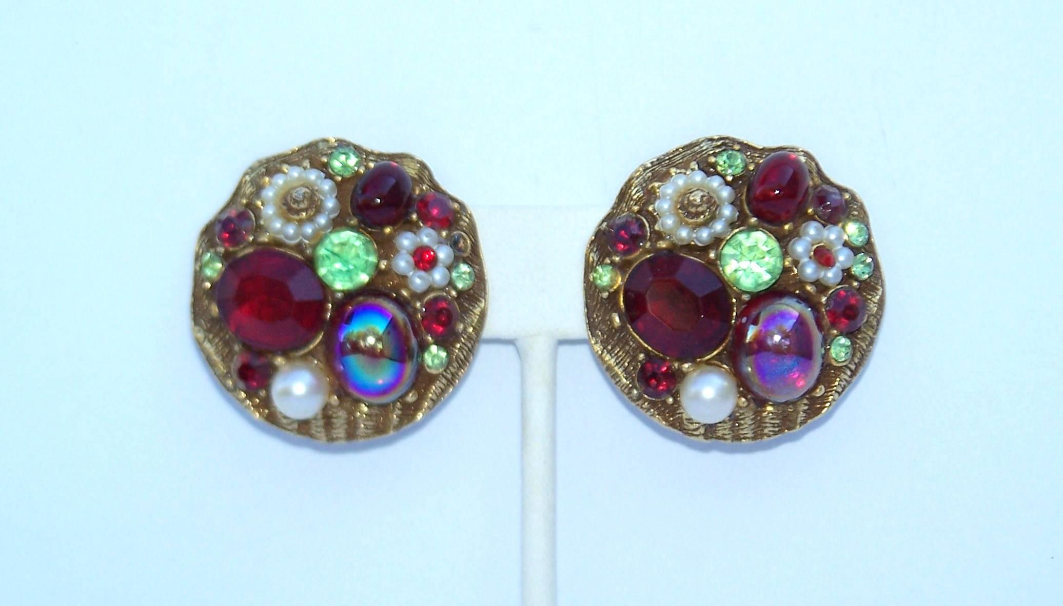 These 1950's clip on earrings look like the booty from a treasure chest...rubies, pearls, emeralds, gold...all costume but lovely nonetheless.  The scalloped shape base is weighty and detailed with a subtle sea shell design.  Though unsigned, they