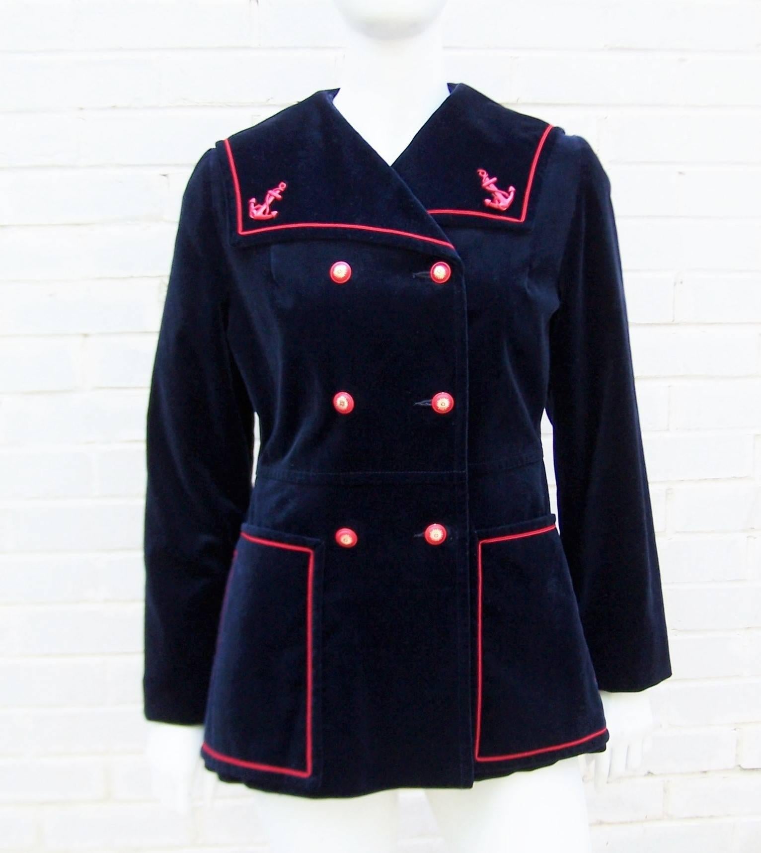 All aboard!  This adorable blue velveteen sailor style jacket is embellished with red satin corded trim, anchor charms and starburst buttons.  The double breasted front and large portrait collar complete the nautical look and the large side pockets