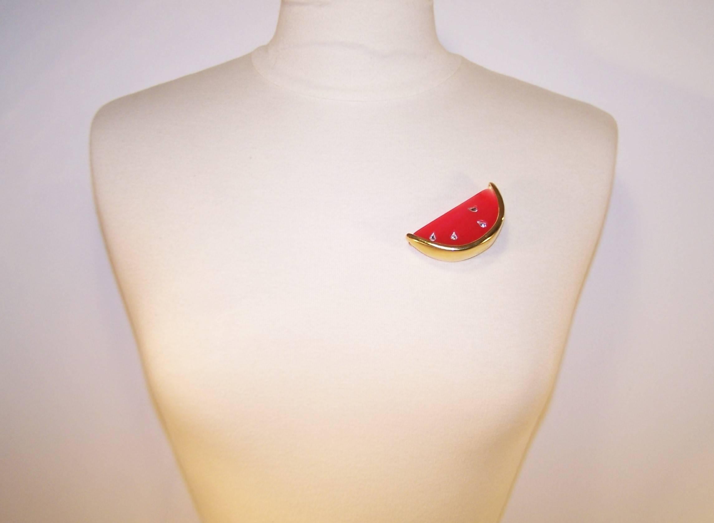 Much like his lovely clothing designs, Hubert de Givenchy created elegant and feminine costume jewelry starting in the 1950's and continuing throughout his career.  This watermelon brooch is made from red resin with teardrop shaped crystal