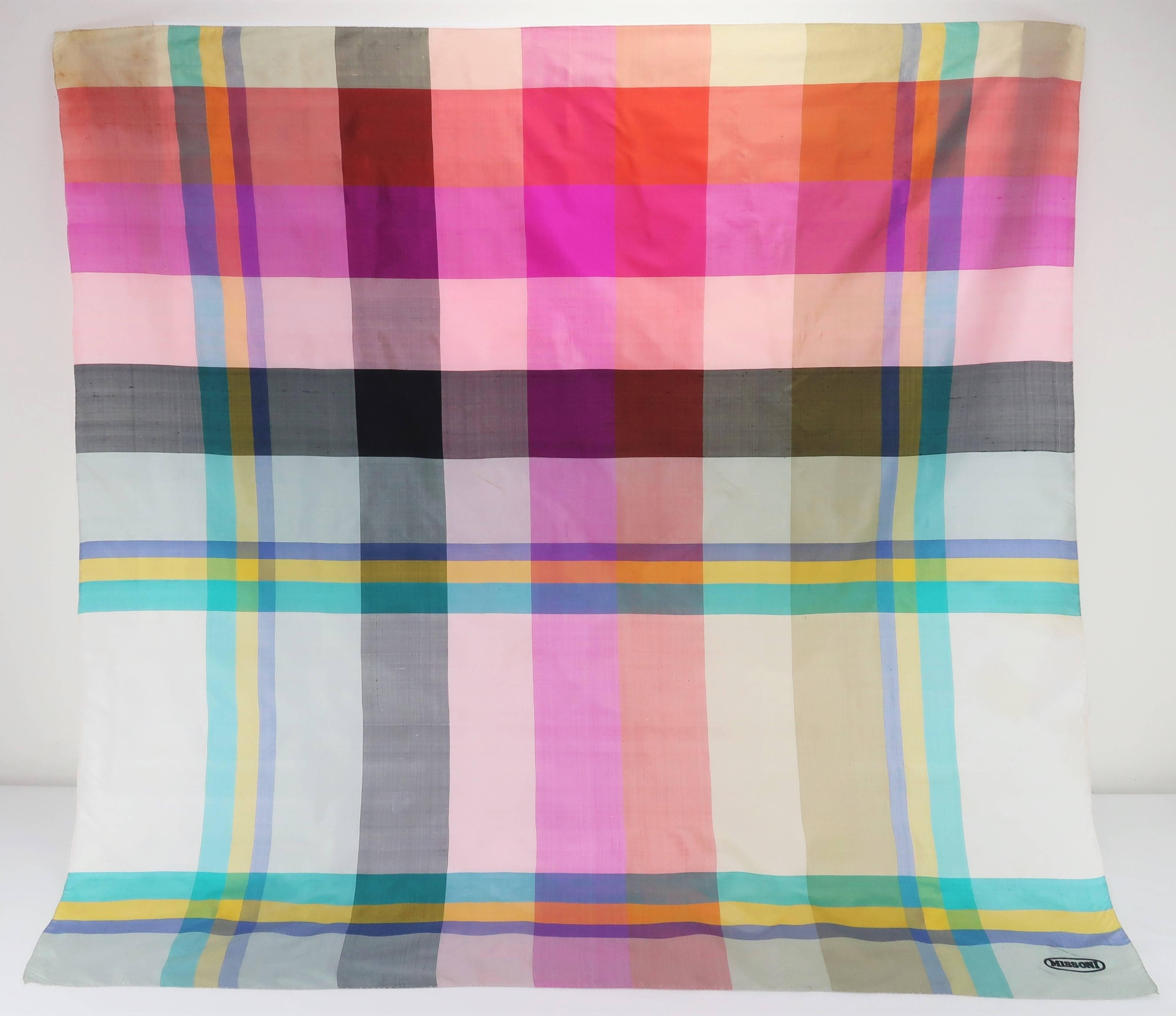 The brilliance of exotic jewel tone colors is present in every square inch of this Missoni raw silk scarf wrap.  The look is a bit of a departure for the famous Italian fashion house though the colors and quality of the fabric certainly fit the