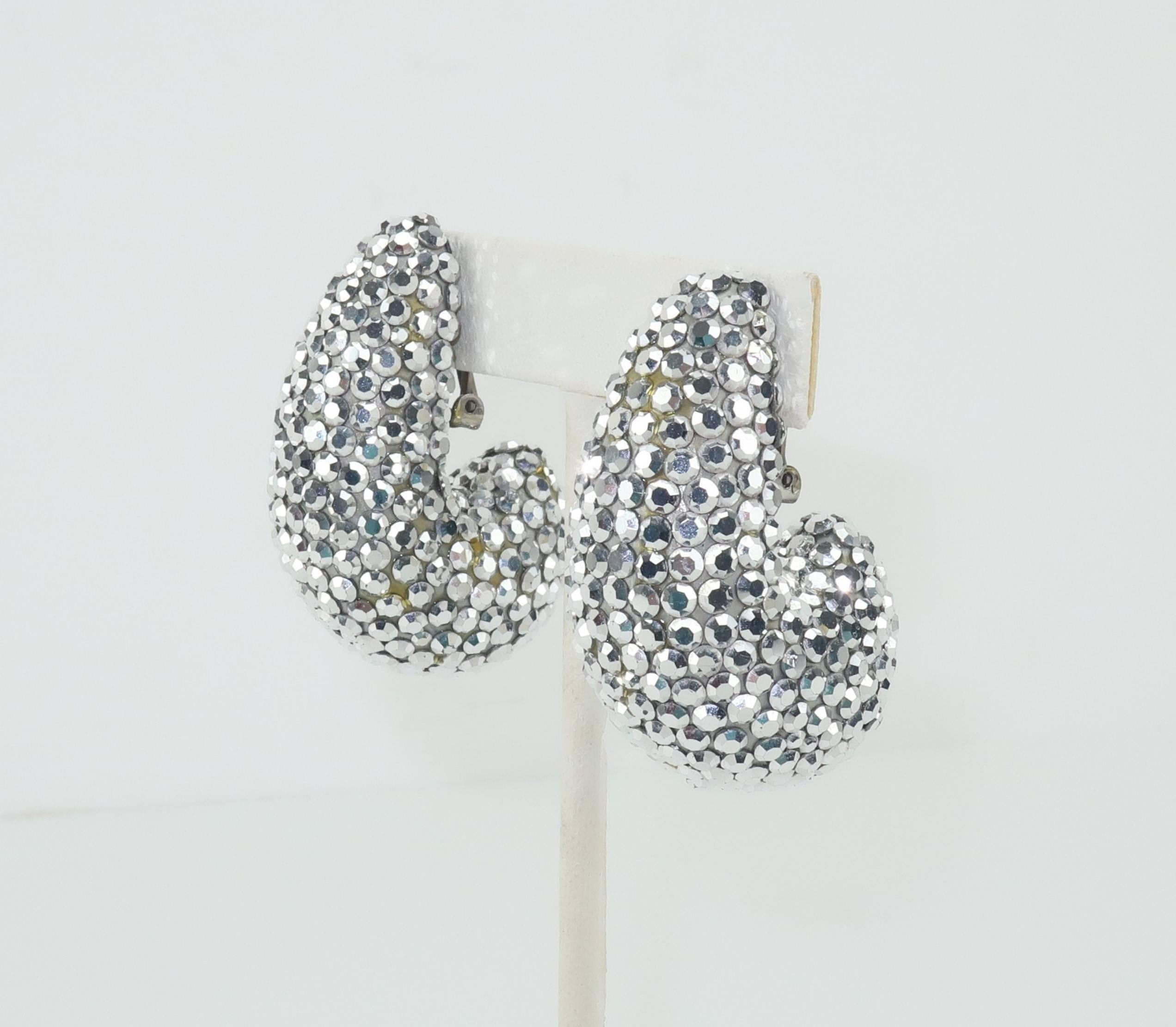 Disco ball perfection!  These 1980's Richard Kerr earrings are mesmerizing.  The nautilus shaped clip ons are fully encrusted in silver pave crystals that catch the light at every turn.  Each earring measures 1.88