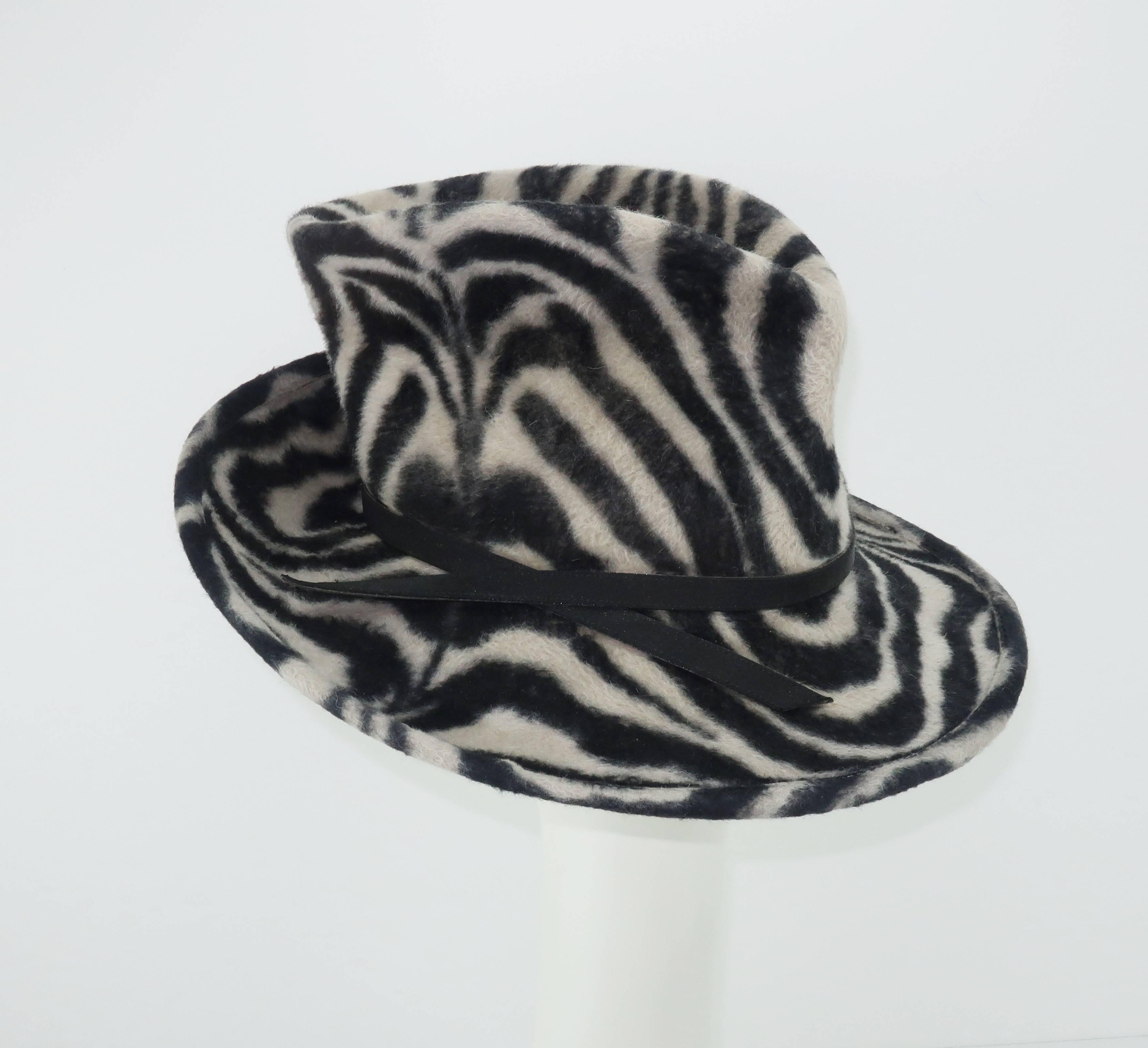 Wild and woolly!  This Philip Treacy hat has an abundance of attitude and style.  The stylized fedora shape is upturned, downturned and pinched for the ultimate fashionable effect.  The soft wool resembles a faux fur in a light gray and black animal
