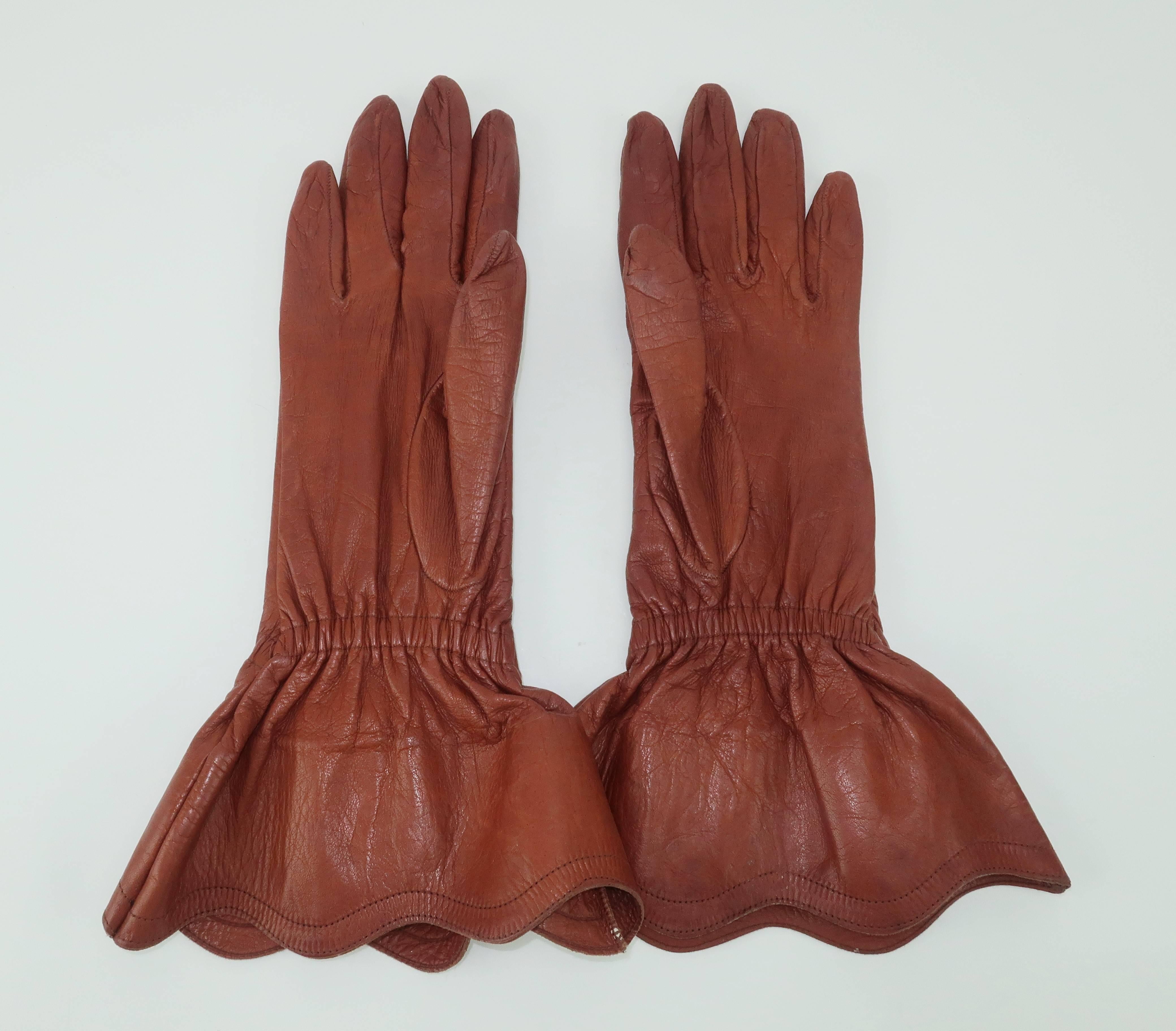 Yves Saint Laurent is throwing down the gauntlet!  Of course there is no challenge when it comes to these fashionable cognac brown leather gloves.  The fine Italian leather is styled with detailed seams at the backhand and scalloped cuffs to protect