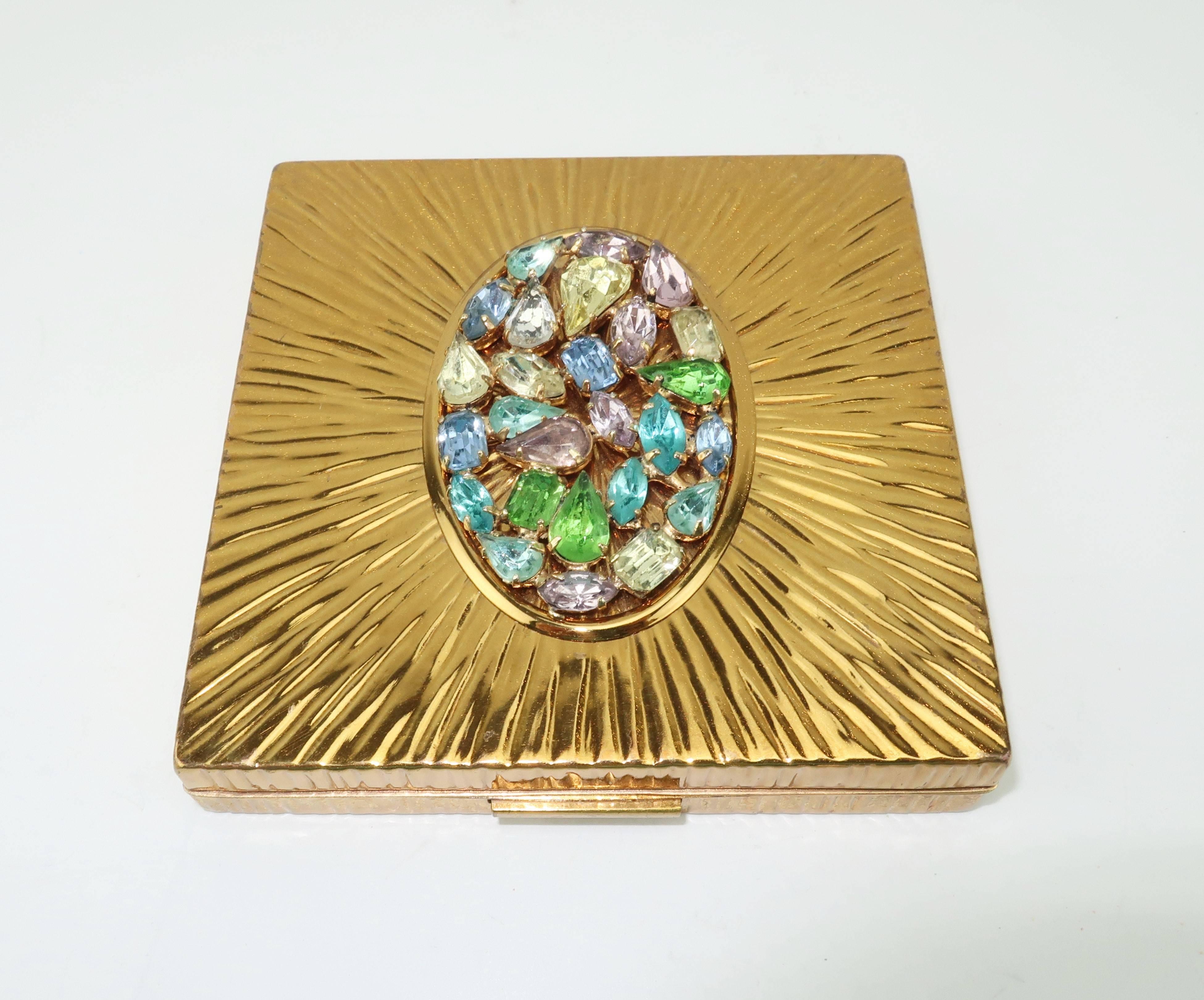 What a dazzler!  This Evans compact with a gold tone starburst pattern is embellished with pastel crystal rhinestones.  The Evans Co. can trace it's roots back to early American button makers and in the early 1900's wisely saw an opportunity to