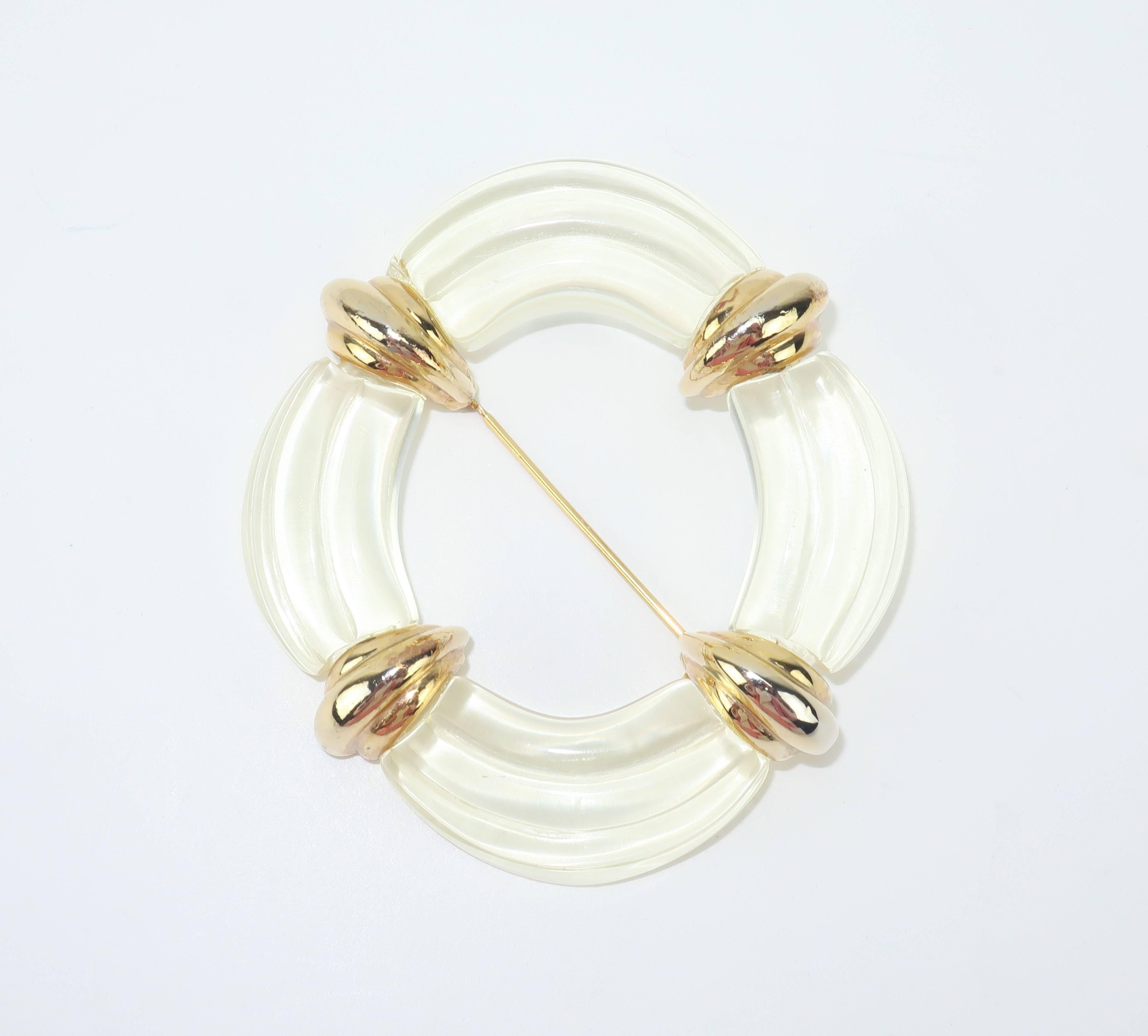 Much like his lovely clothing designs, Hubert de Givenchy created elegant and feminine costume jewelry starting in the 1950's and throughout his career.  This C.1980 lucite brooch is an oval shape with the faux appearance of a drape or swag.  The