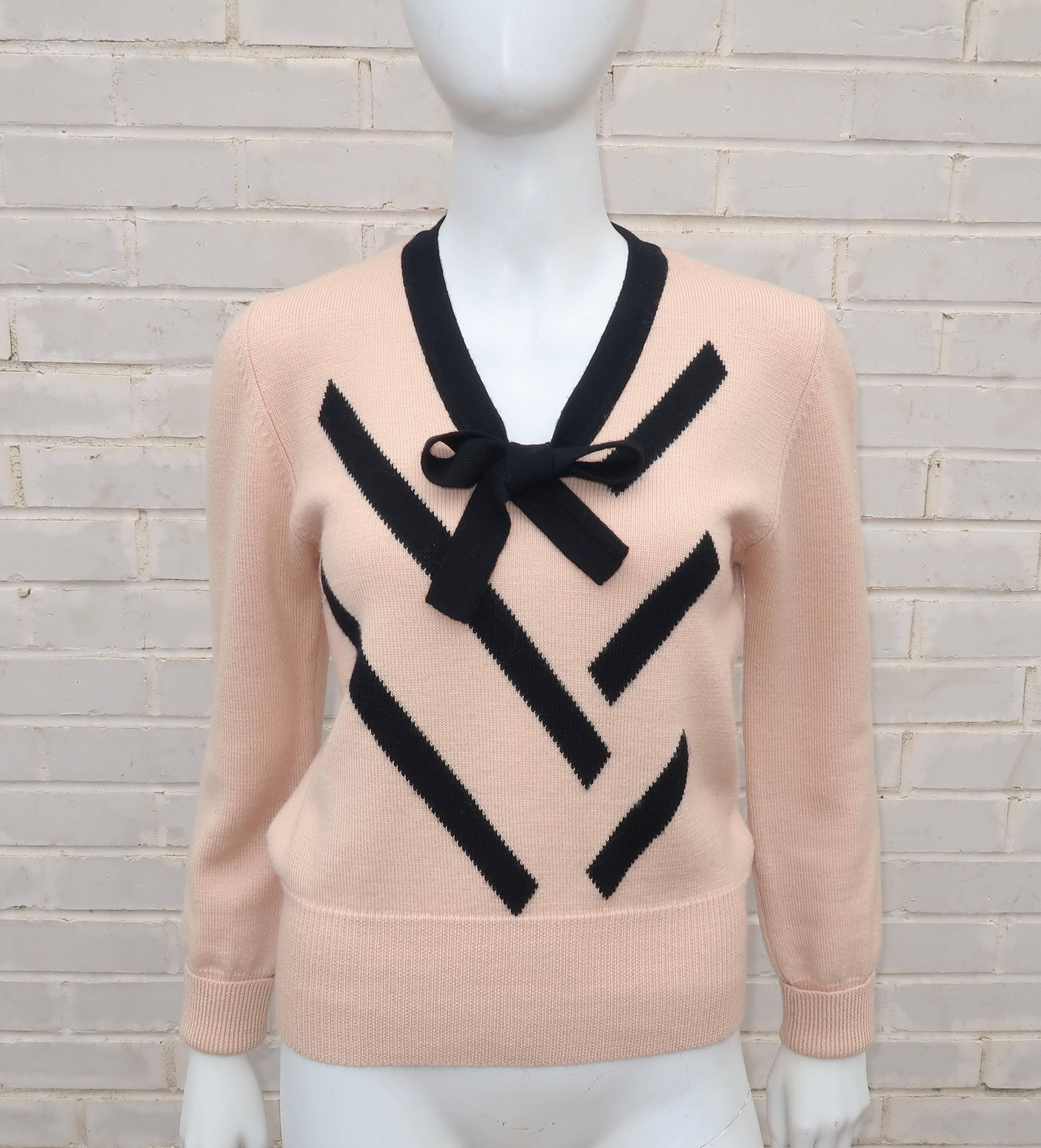Girlish charm!  This 1980's Sonia Rykiel Knits design combines the classic pairing of black and a light beige ... with just a touch of ballerina pink.  The pullover silhouette is accented with a scoop neck embellished with a tie and the front bodice