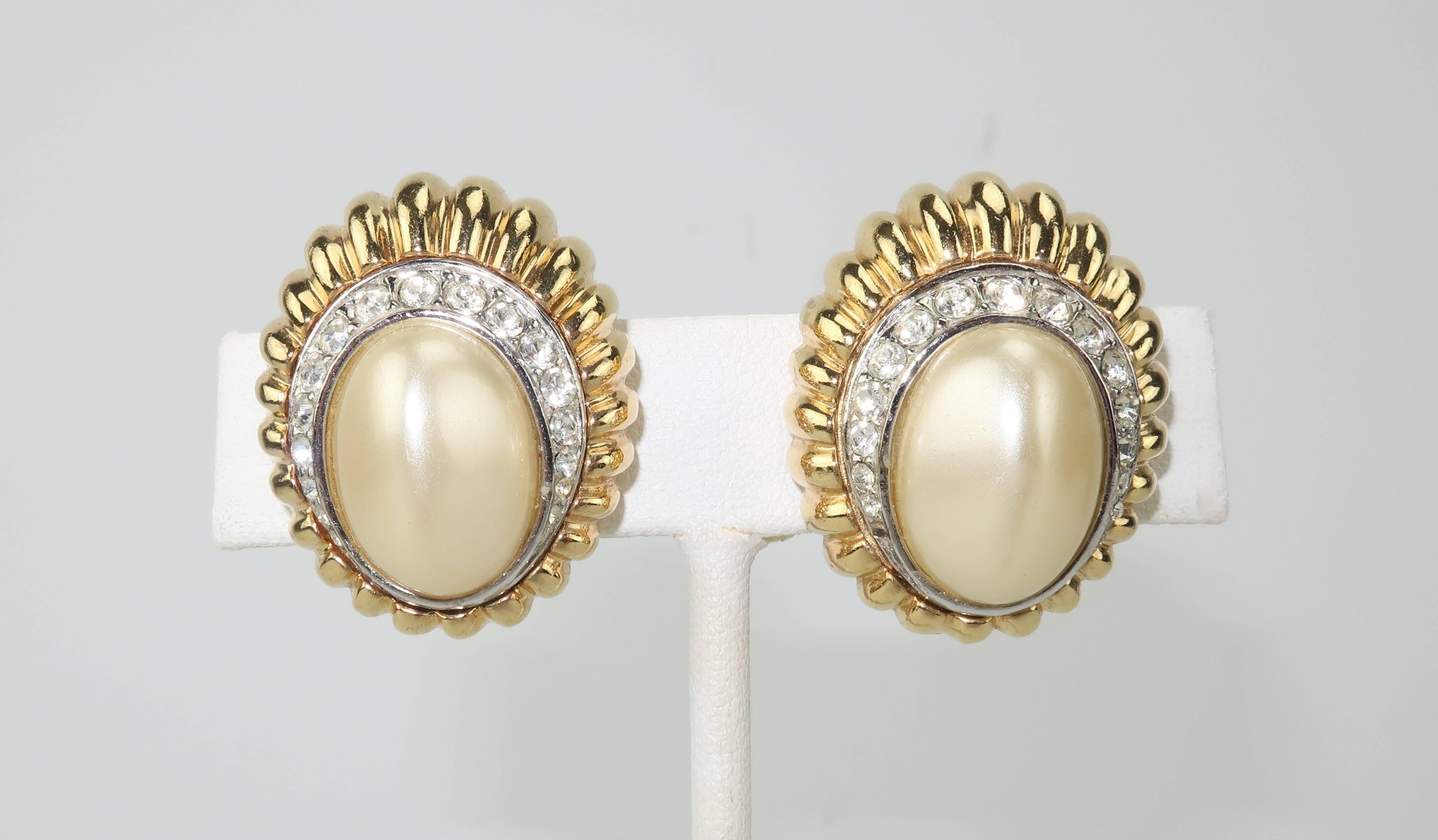 Glorious glamour alert!  These clip on earrings are by Ciner, an American costume jewelry company known for producing high quality accessories since the 1930's.  The gold tone scallop shaped base is decorated with graduated crystal rhinestones and a