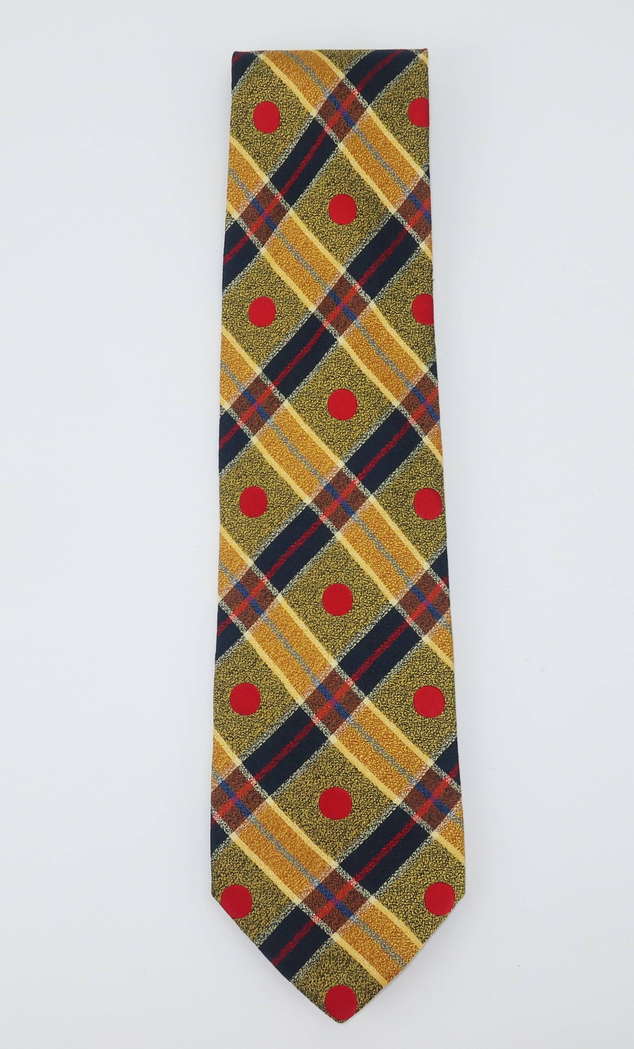 Emanuel Ungaro creates a visually vibrant men's necktie from a plaid patterned silk incorporating blue, gold and crimson red.  Perfect fashion statement to update your favorite suit.
MEASUREMENTS
The necktie measures 56.5