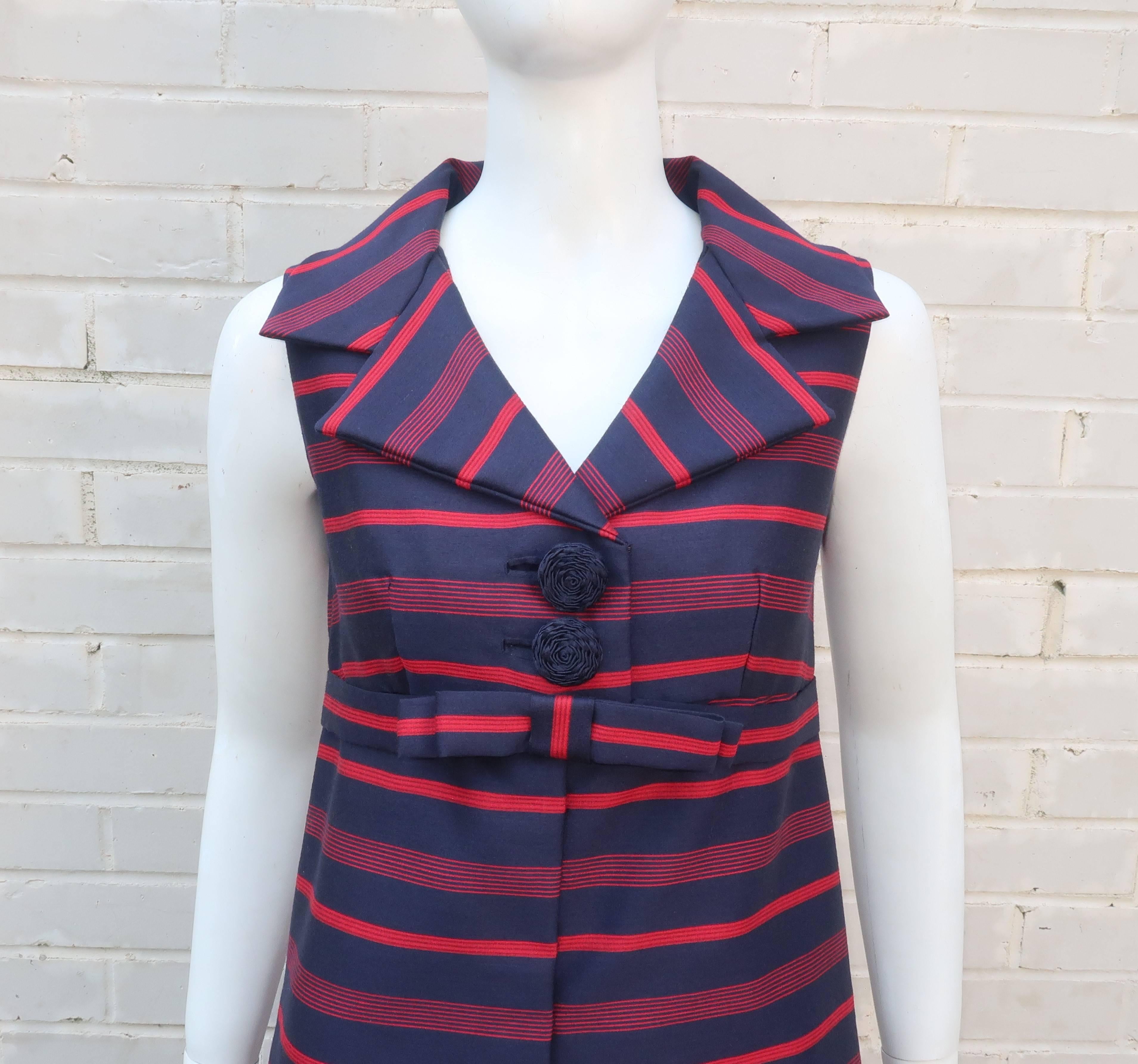 An adorable 'That Girl' style 1960's custom made a-line dress in a dark blue and red striped fabric that feels like a silk and wool blend.  The fabric has the perfect weight and stiffness to create a sculptural silhouette which is accented by a