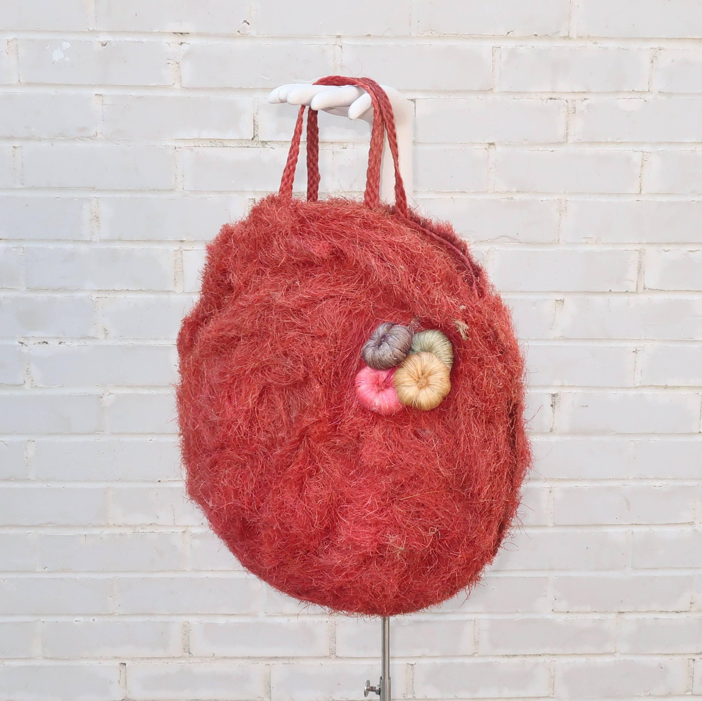Step into summer with a fun and functional 1950's straw tote handbag.  The exotic design will transport you to the tropics with the body of the large handbag woven in coconut fibers that have the texture and look of straw colored a marvelous shade