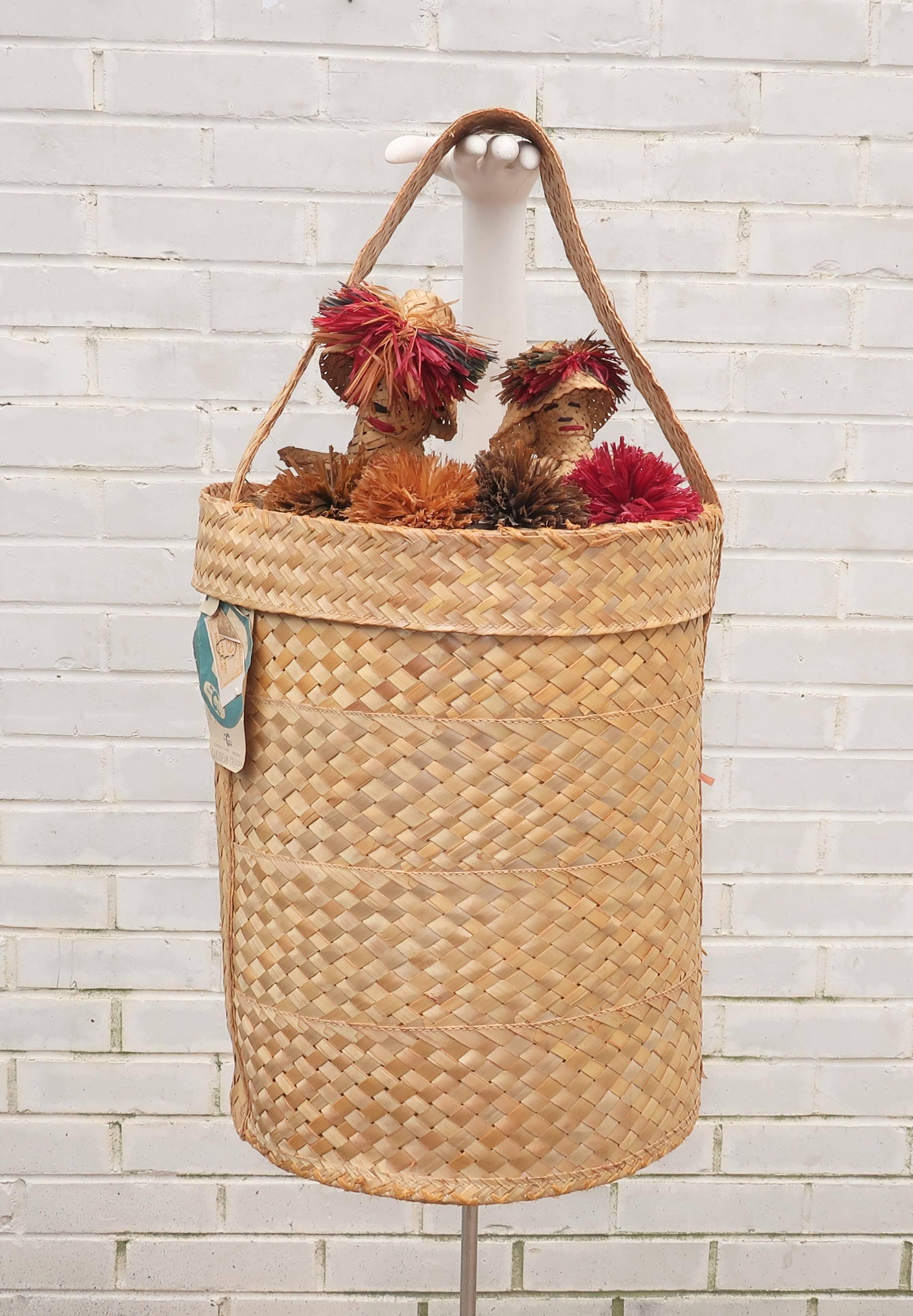 Adorable!  You will have the best beach companions with this 1950's straw beach bag complete with Mr. & Mrs. Nassau along for the ride.  The large cylinder shaped bag opens at the top by sliding the lid up on the wide strap to reveal a roomy