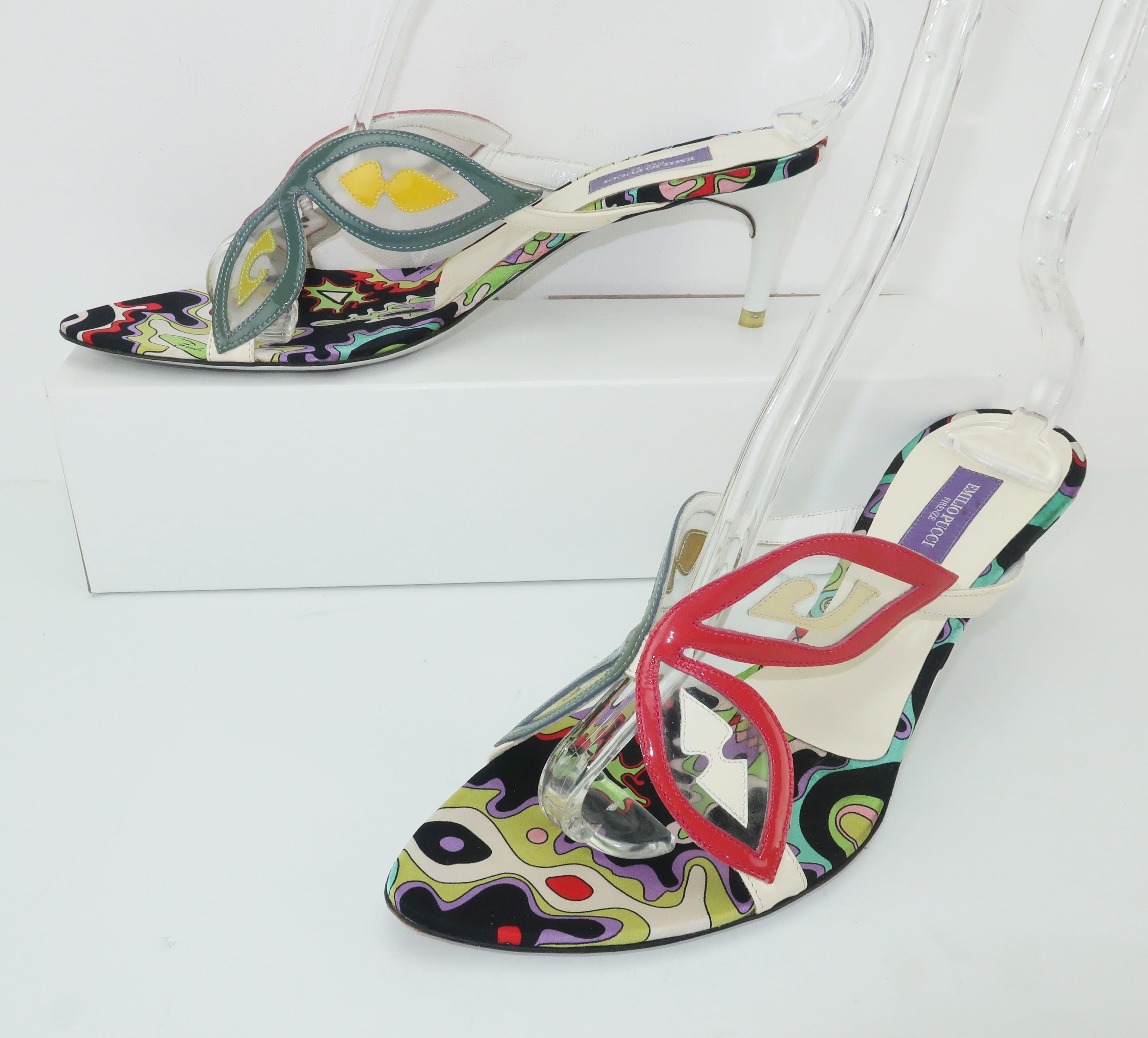 These Pucci mules are more fun than you can shake a butterfly net at!  The white heeled slide-on sandals are fabricated from clear PVC panels outlined in red, khaki and white patent leathers accented with yellow, creme, white and chartreuse shapes