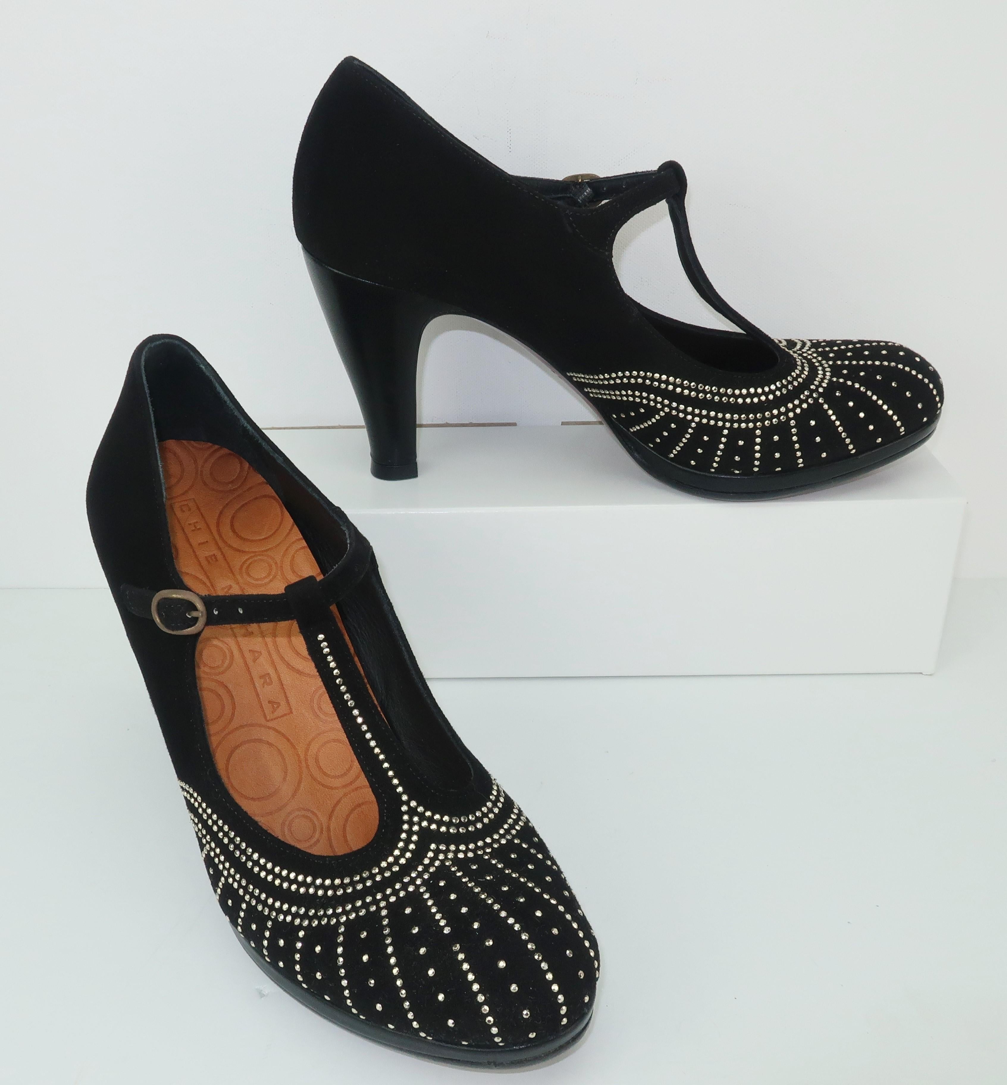 These contemporary shoes by Chie Mihara are a great homage to the Art Deco inspired footwear styles of the 1930's.  The black suede body is a t-strap silhouette with a modest leather platform and 3.75